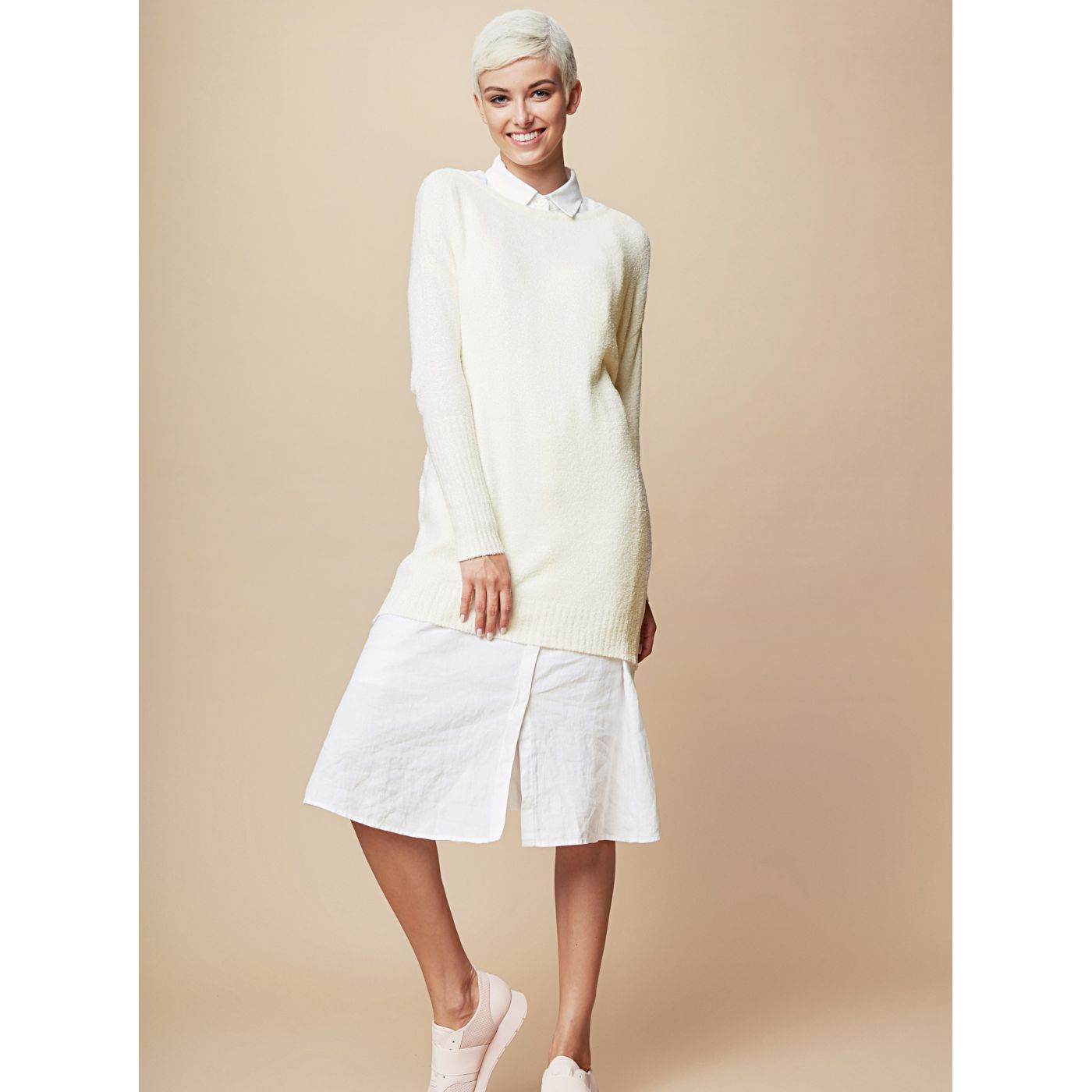 Cream sweater mini-dress with long sleeves and touch me ties.