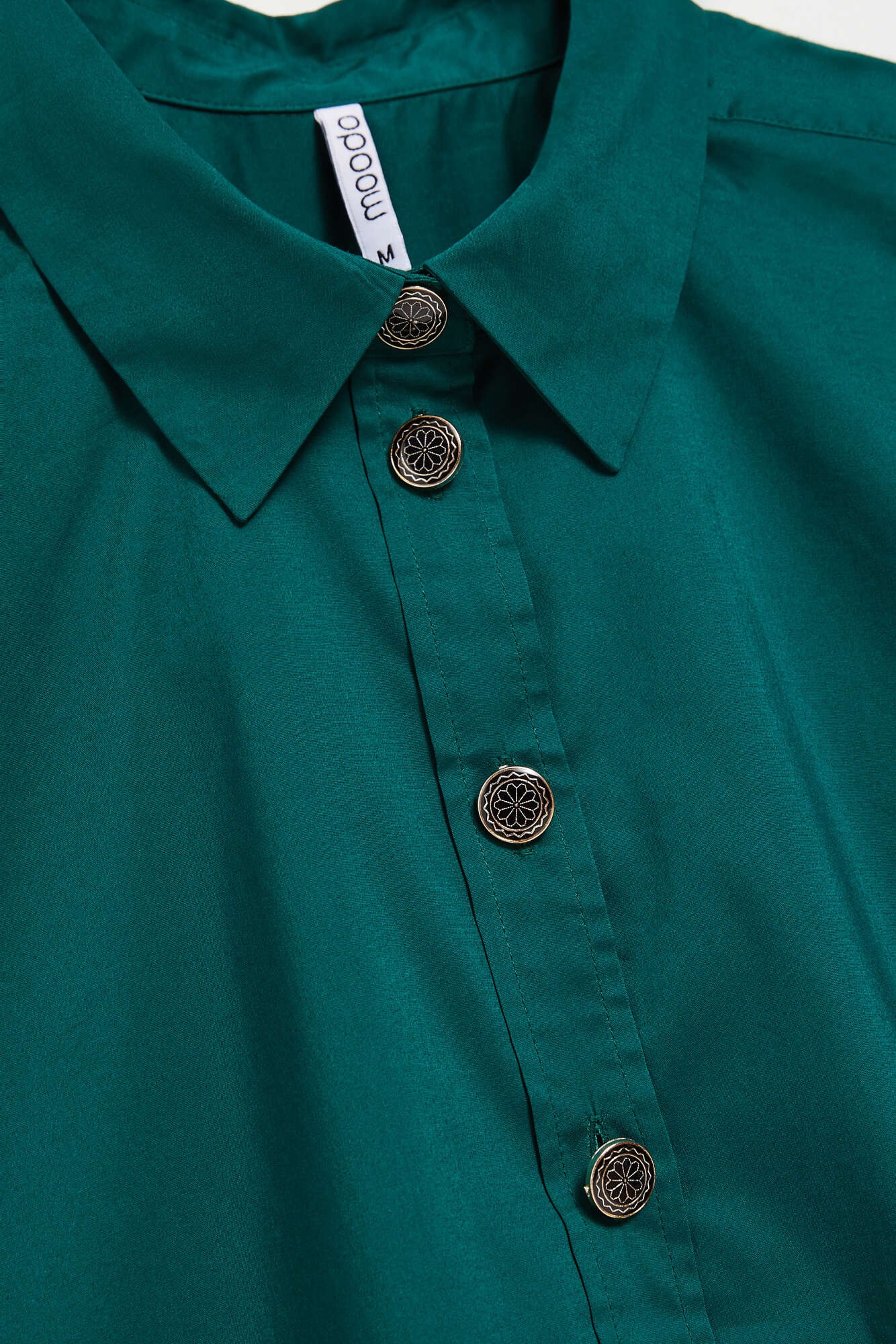 Shirt with decorative buttons