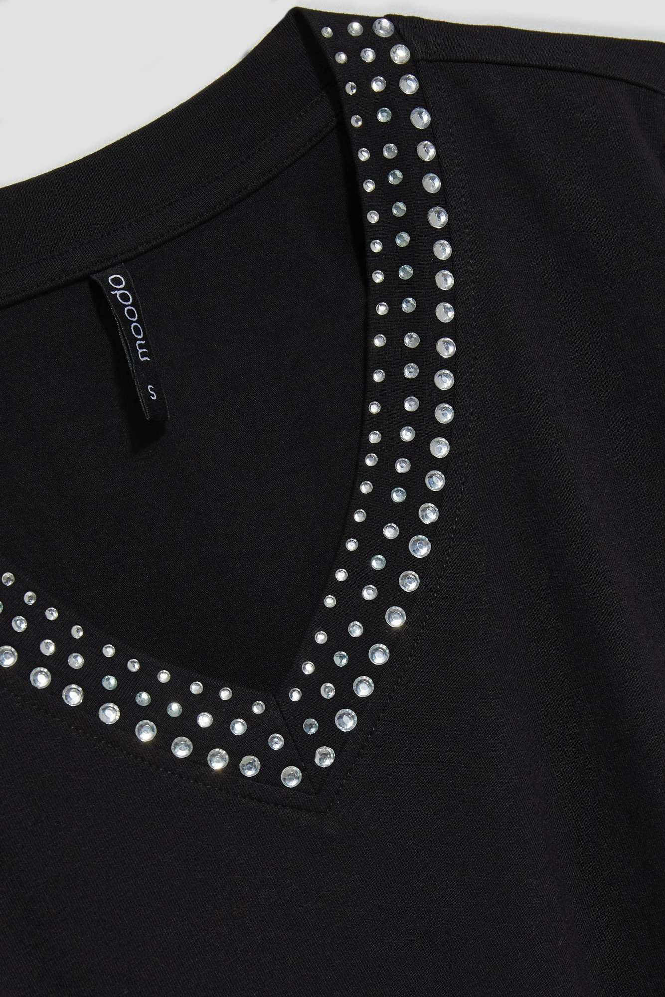 Plain blouse with a decorative neckline