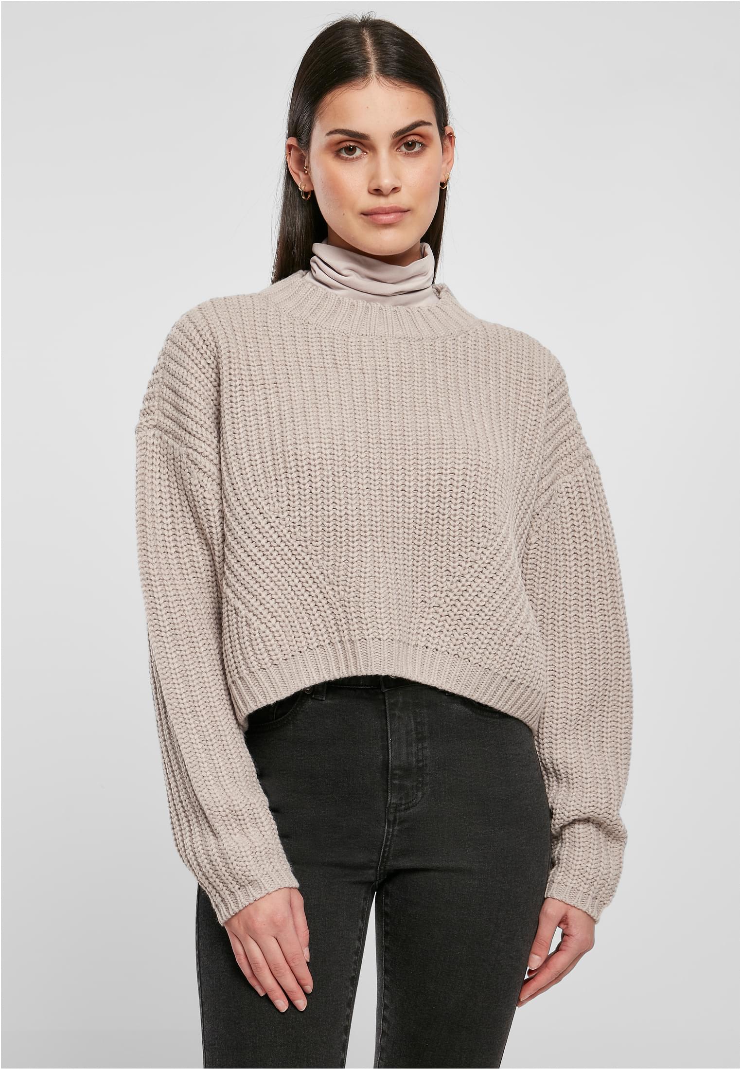 Women&#039;s wide oversize sweater in warm gray color