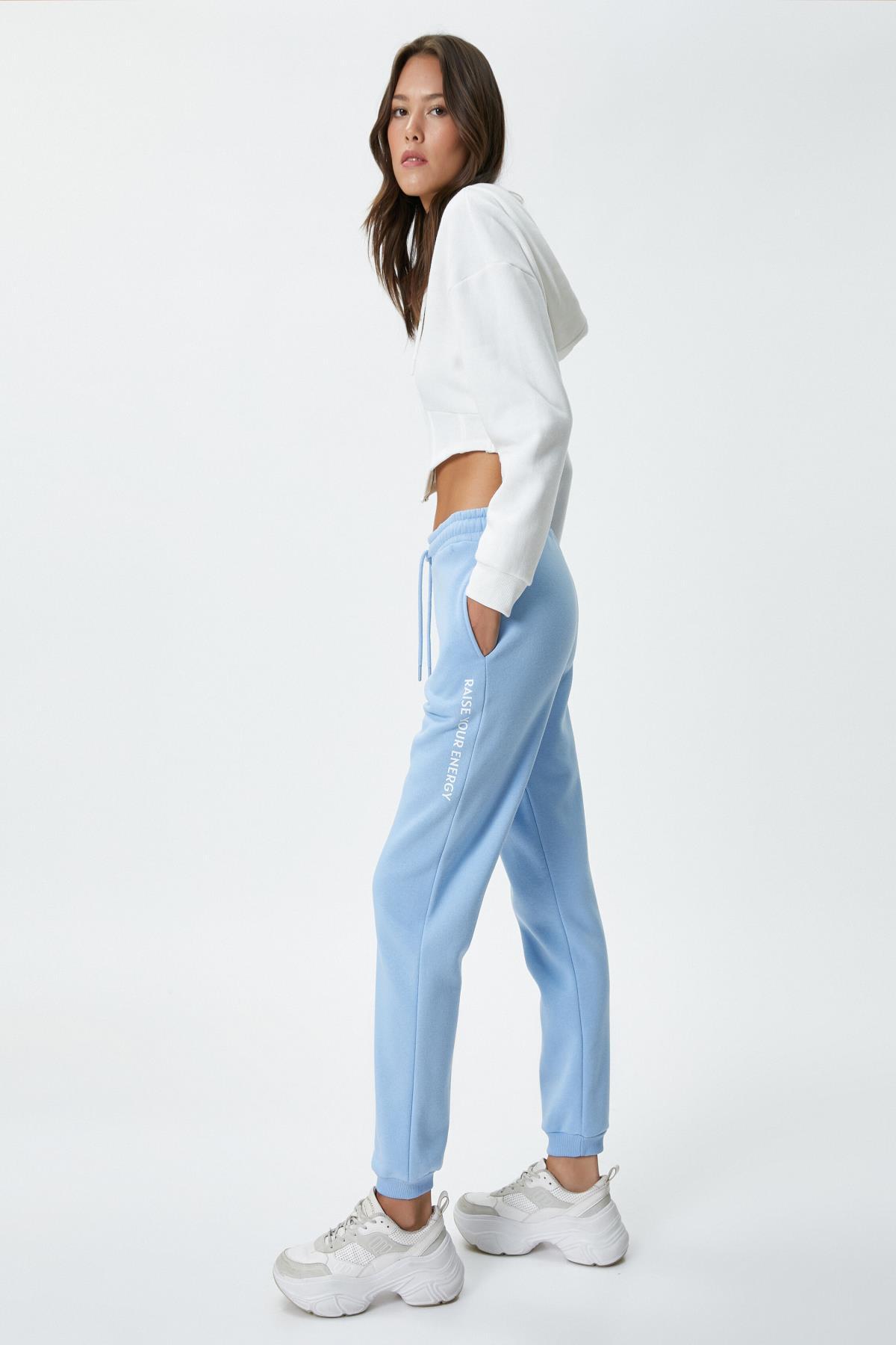 Levně Koton Jogger Comfortable Cut Sweatpants with Pockets Print Detail Tie Waist Cotton Blend Blue