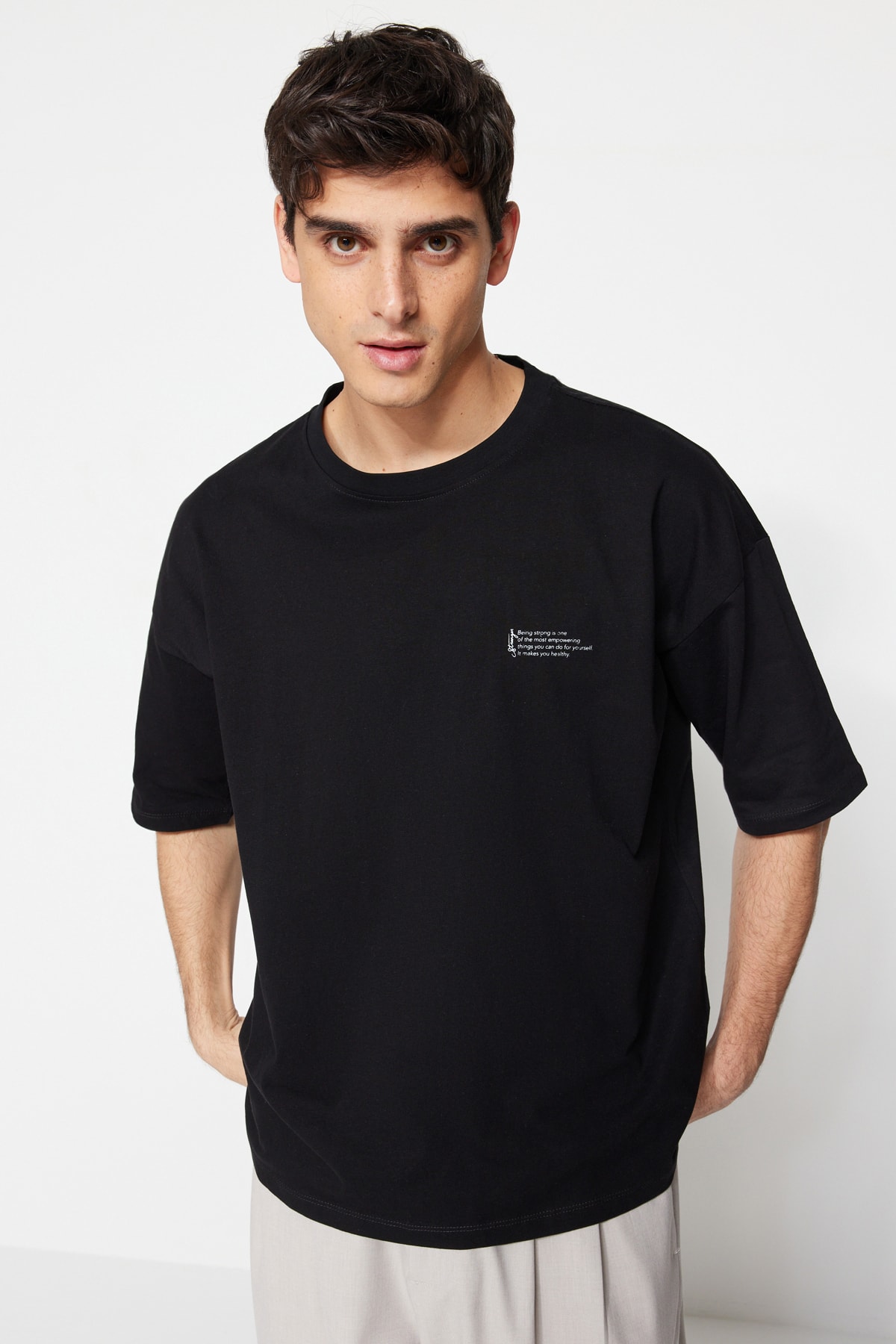 Levně Trendyol Černé oversize tričko se 100% bavlnou s minimálním textovým potiskem