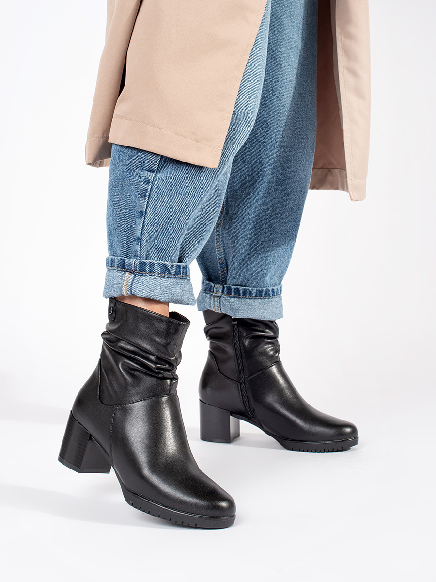 Womens black leather ankle boots with a ruffled upper by Sergio Leone