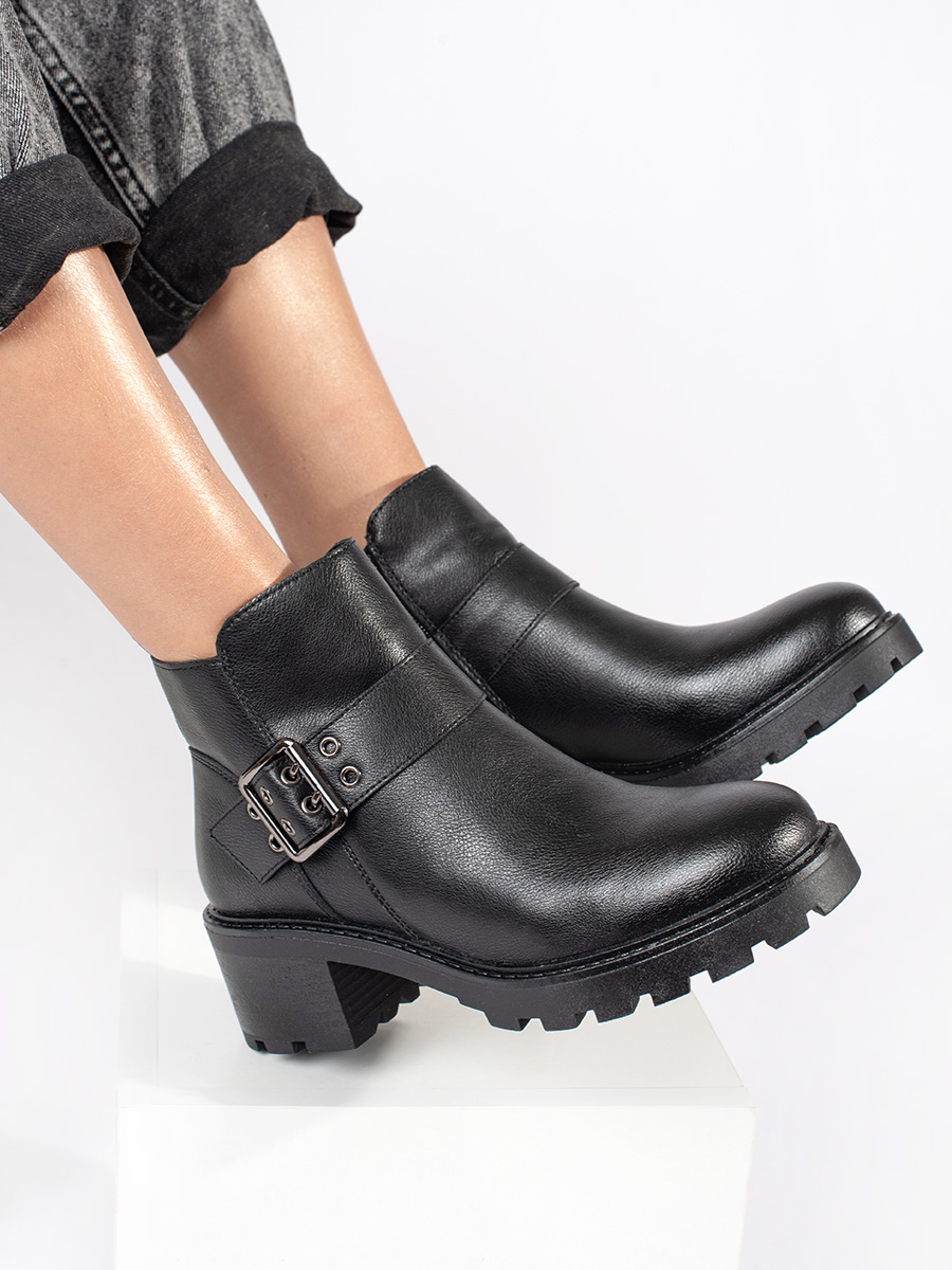 Black womens leather heeled boots with a decorative buckle by Sergio Leone