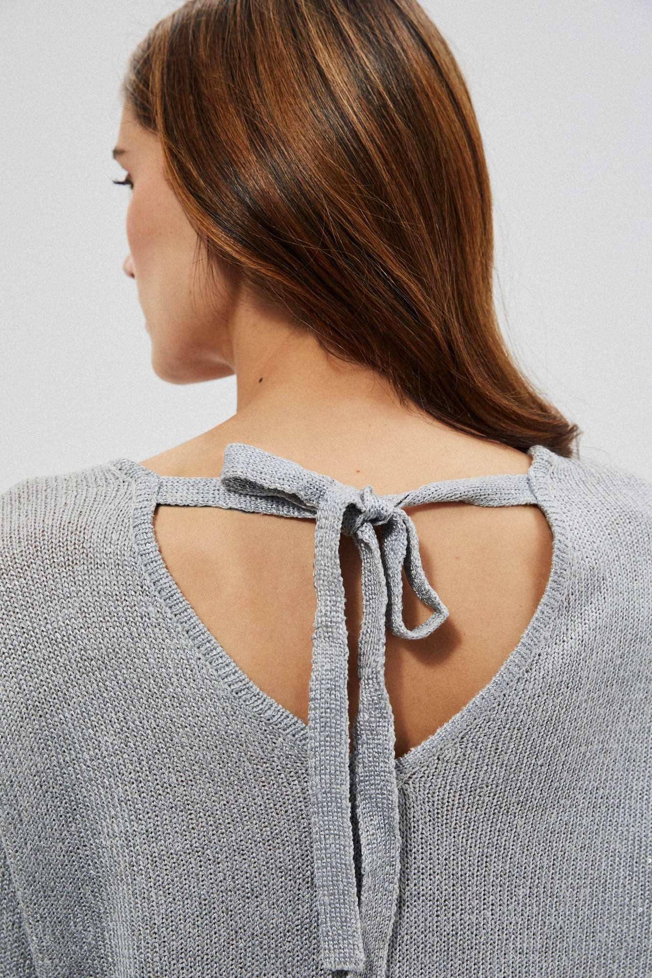 Sweater with a neckline on the back