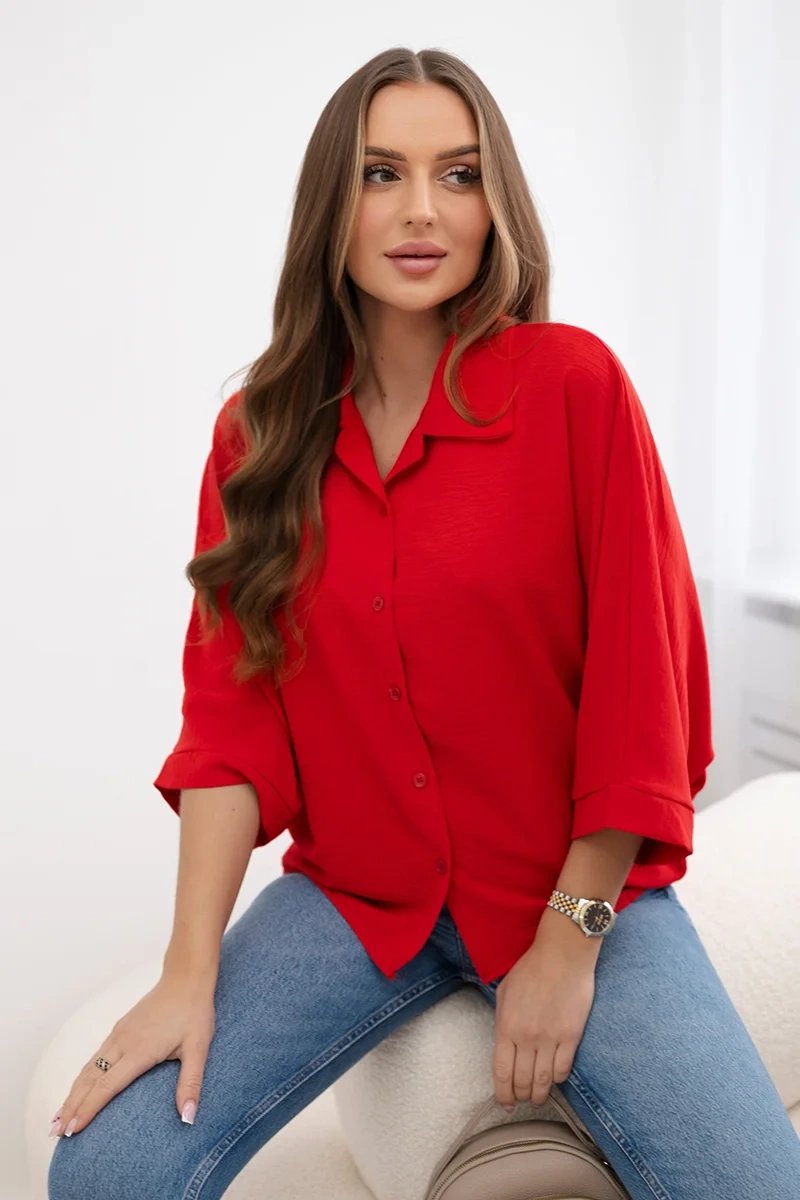 Oversized blouse with red button fastening