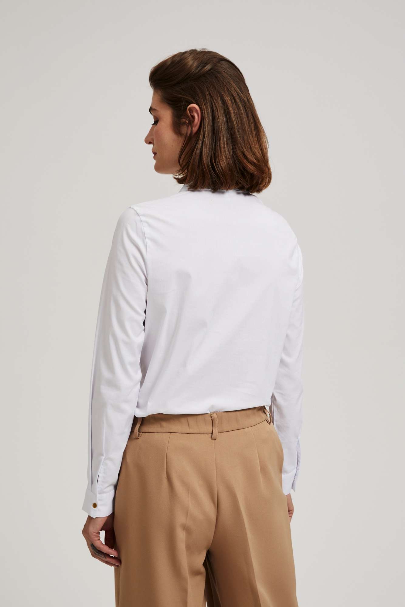 Plain shirt with decorative buttons