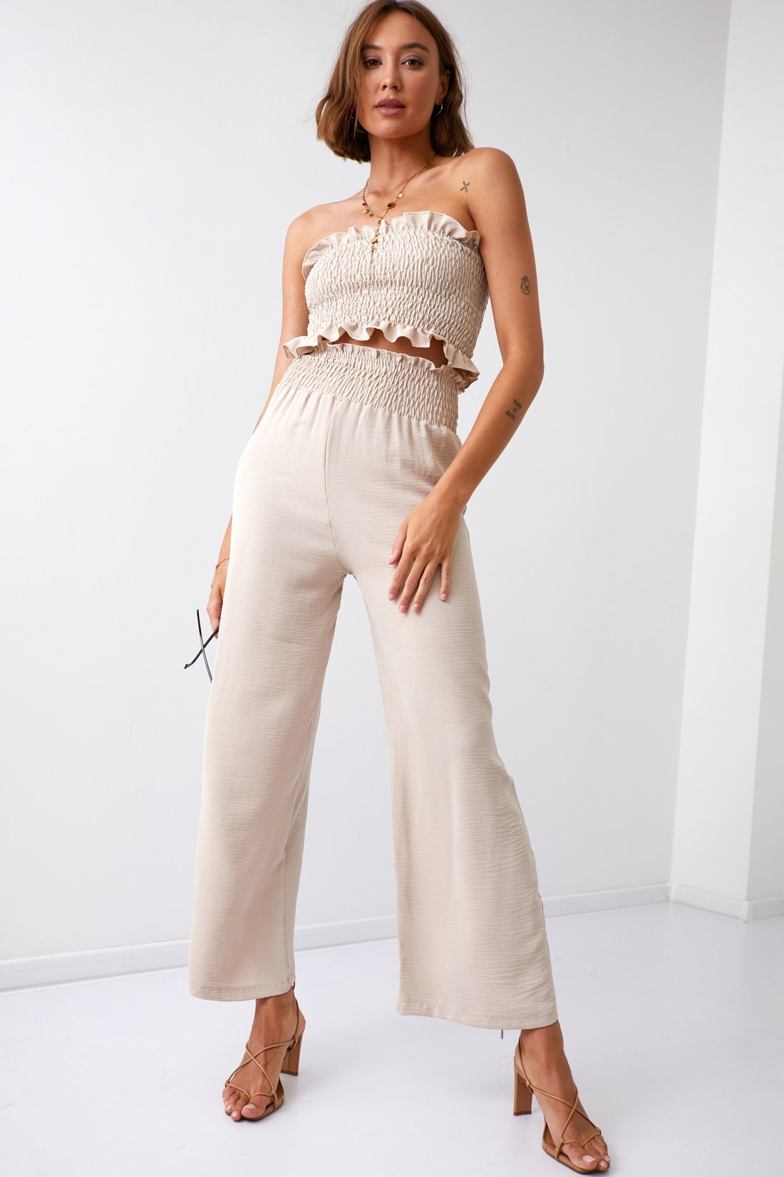 A Set Of Women's Wide Trousers With A Short Pressed Top Of Beige Color