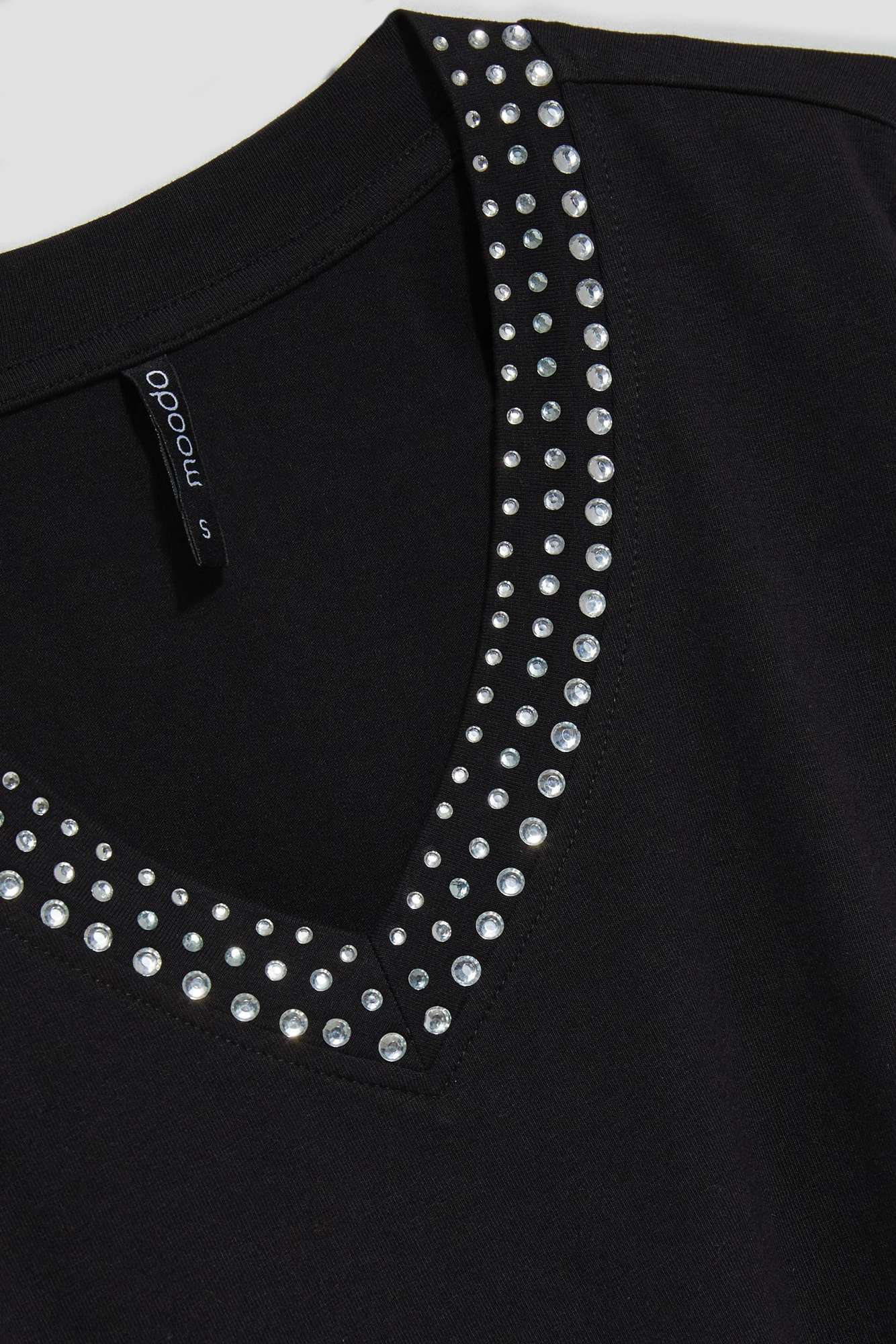 Plain blouse with a decorative neckline