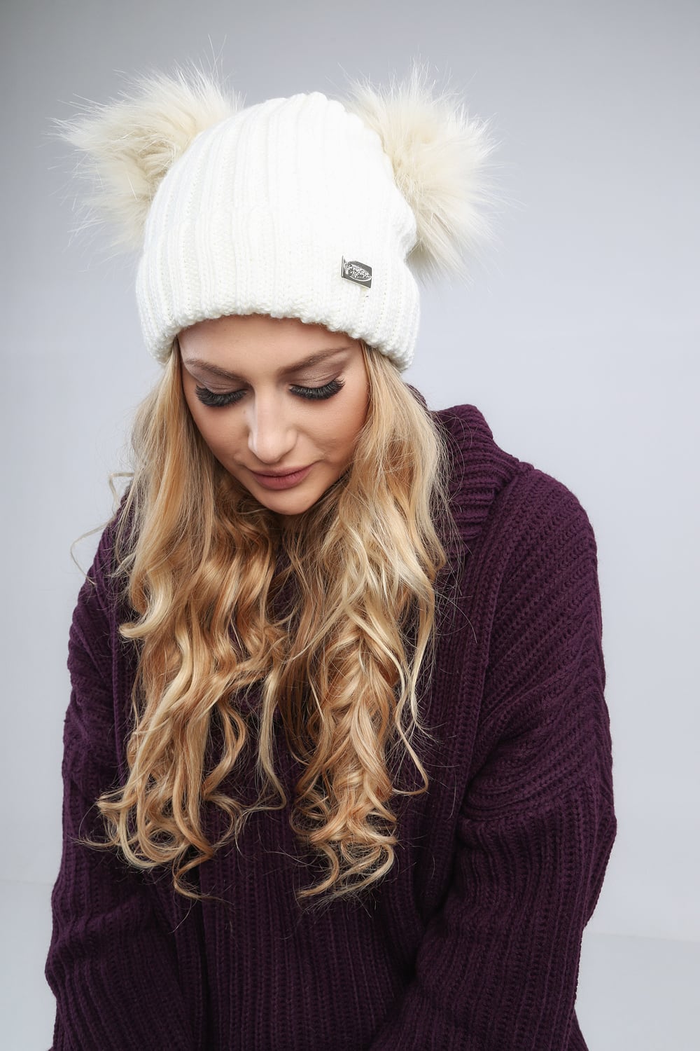 Cream cap with pompom for the winter