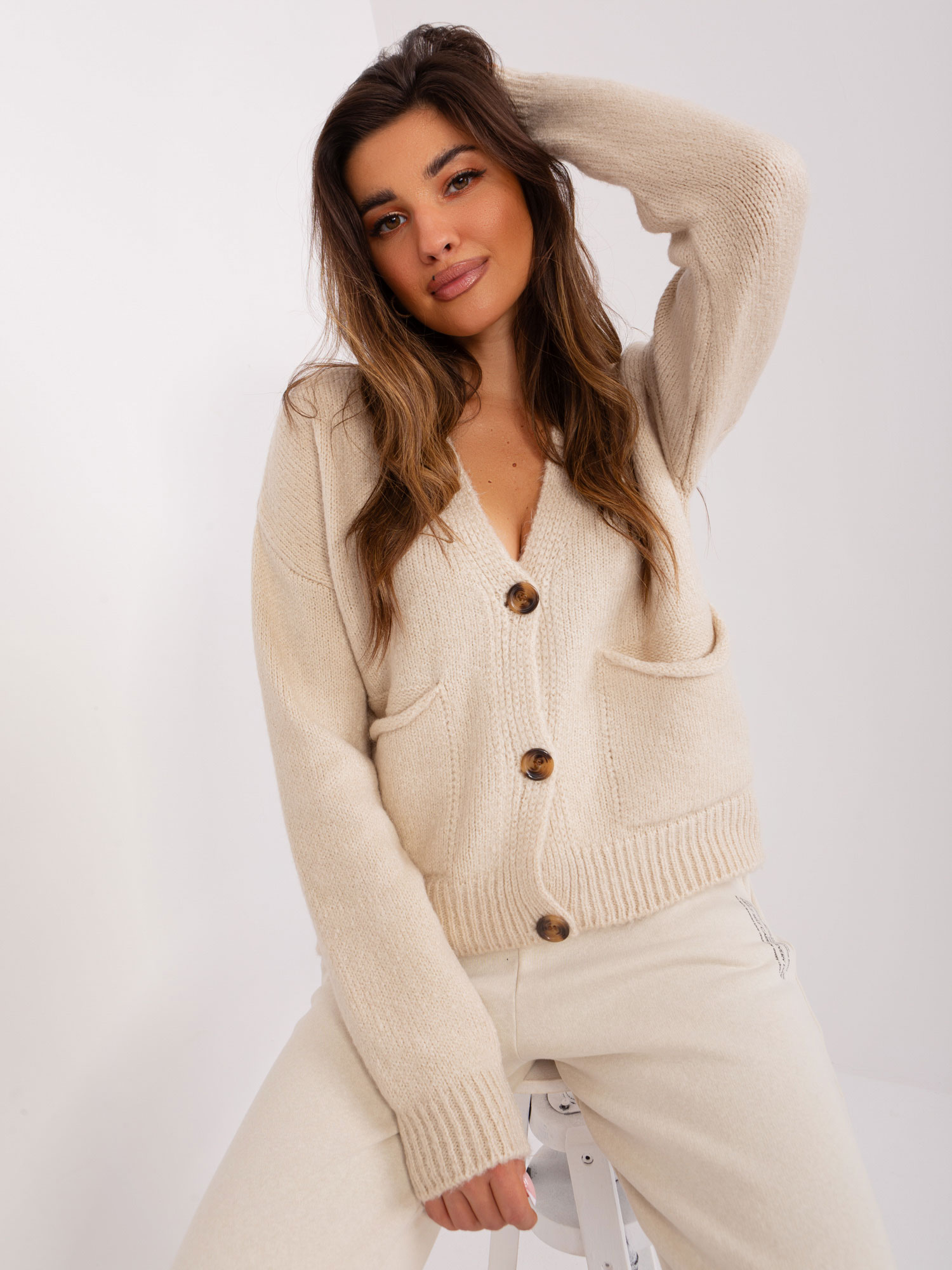 Beige knitted cardigan with a neckline
