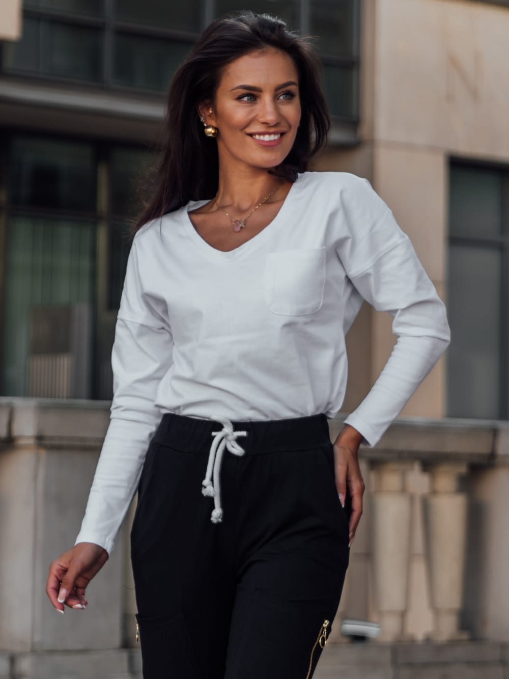 Set of women&#039;s cargo pants and a white and black blouse