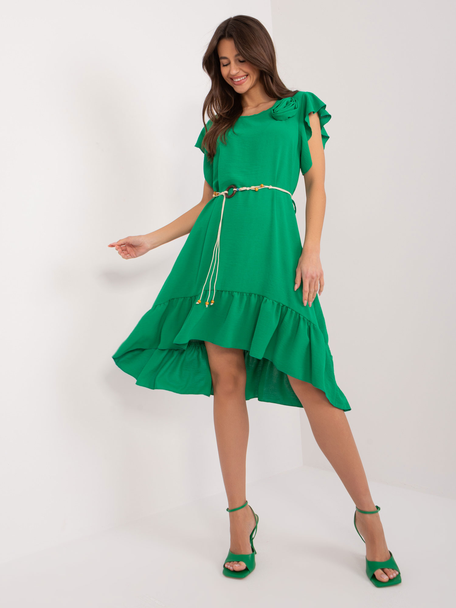 Green dress with ruffles and flower