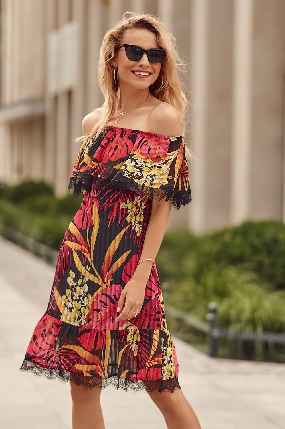 Black dress with a Spanish neckline with purple flowers