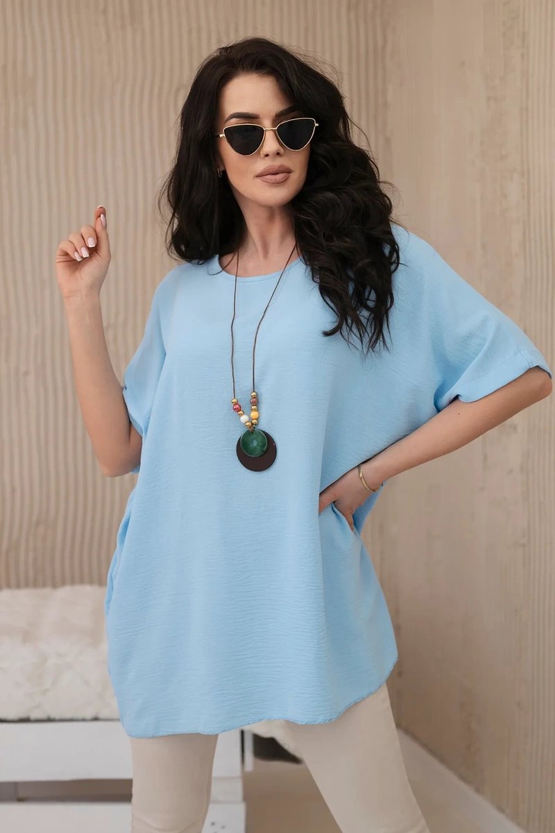 Oversized blouse with blue pendant