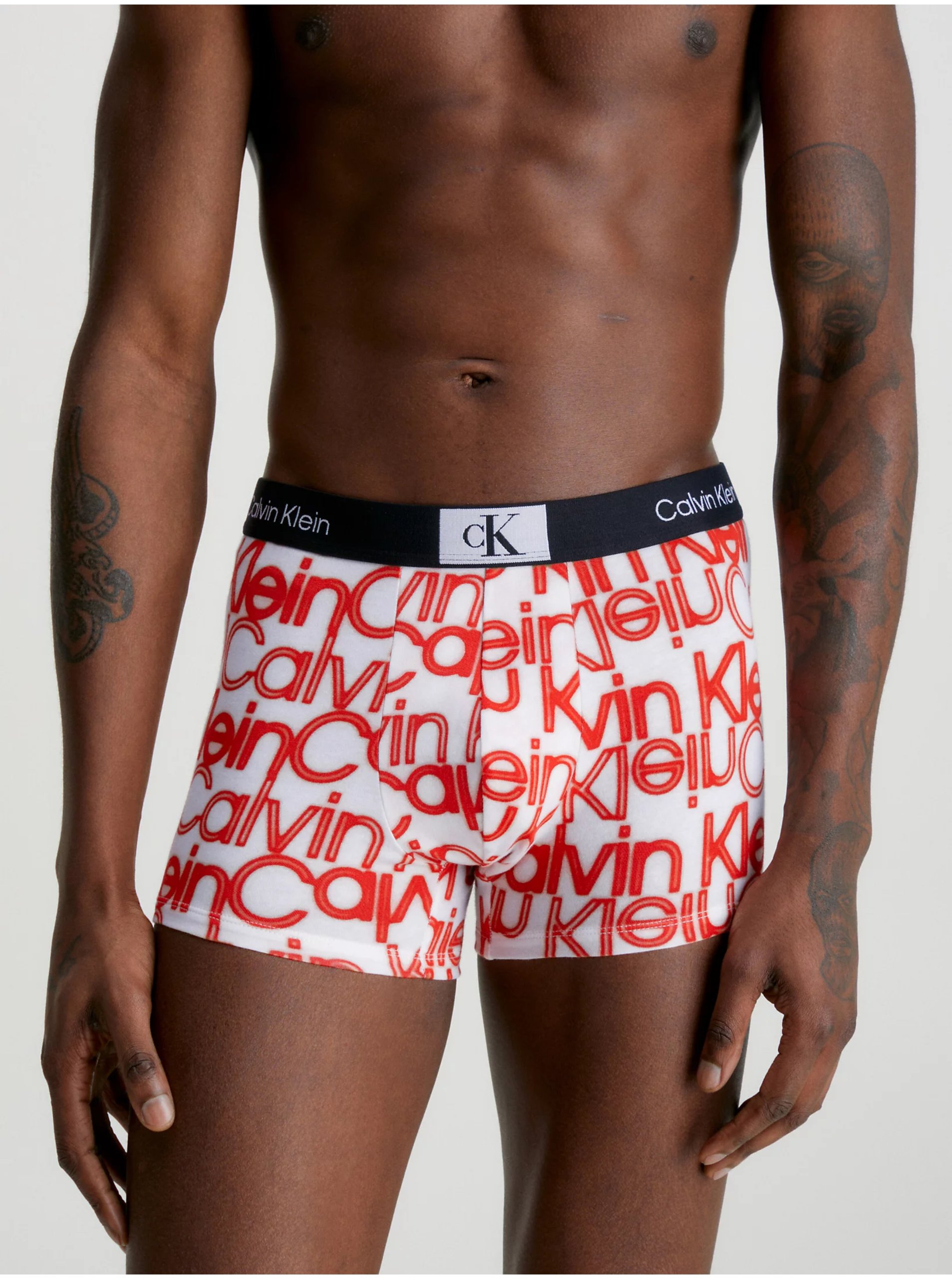 Levně Oranžovo-krémové pánské vzorované boxerky Calvin Klein Underwear - Pánské