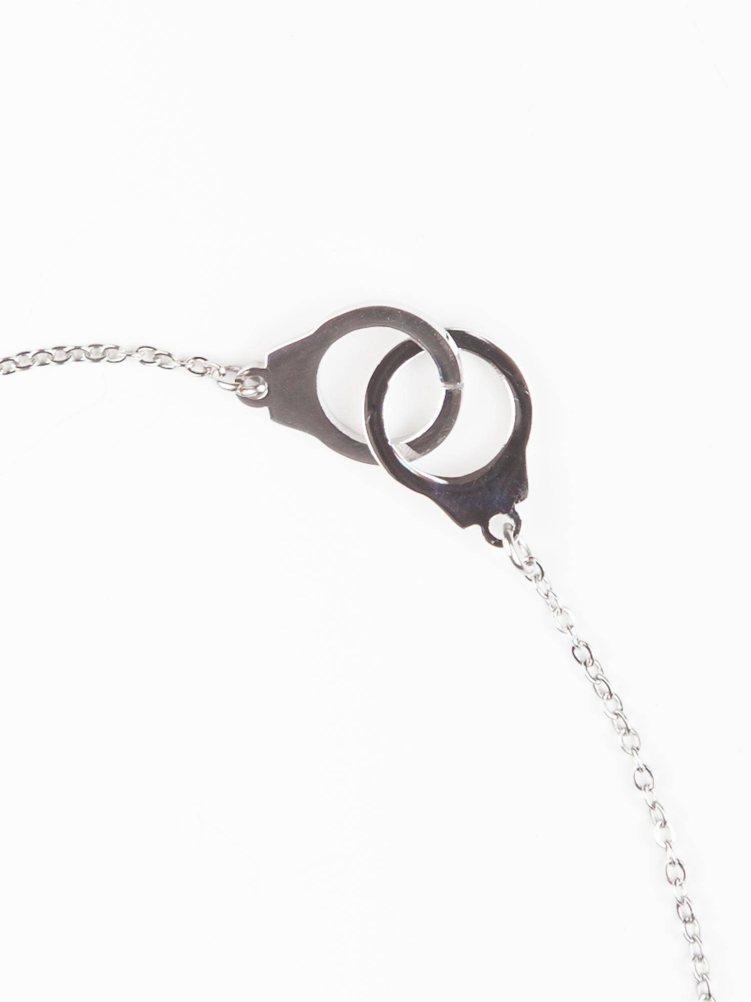 Bracelet on a silver chain decorated with handcuff pendants