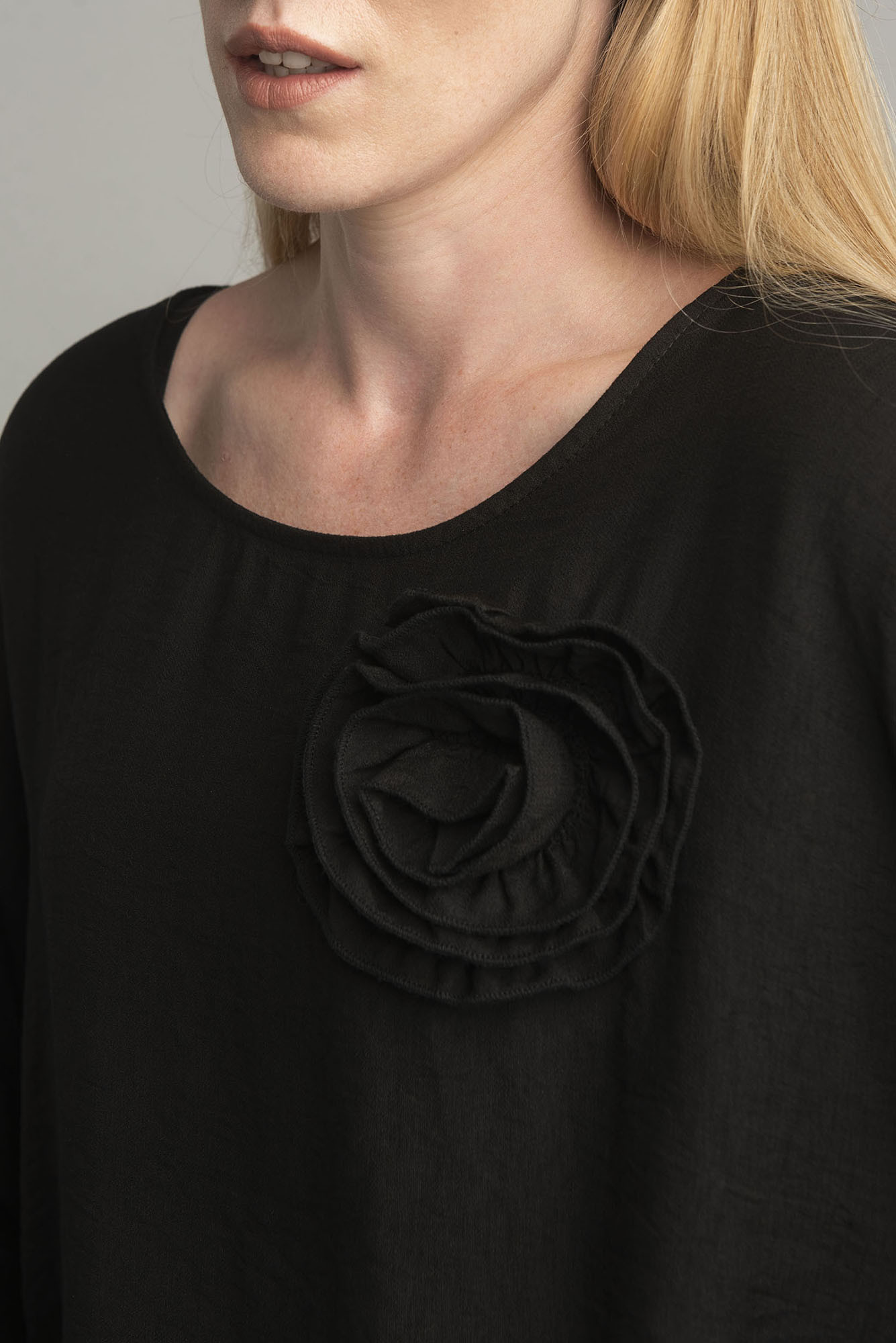 Black oversize blouse with a decorative flower