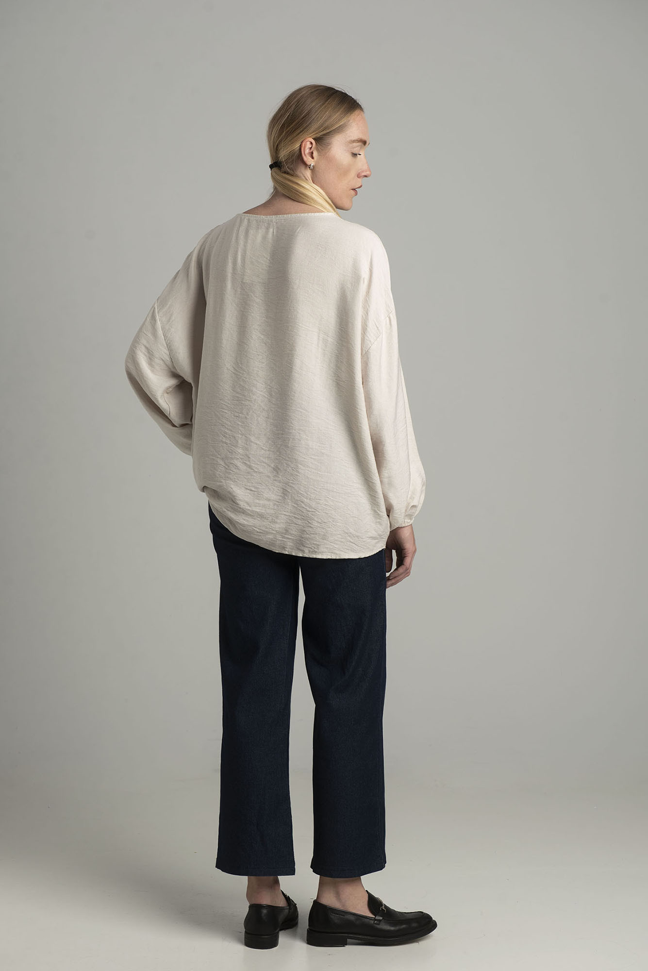 Beige oversize blouse with a decorative flower