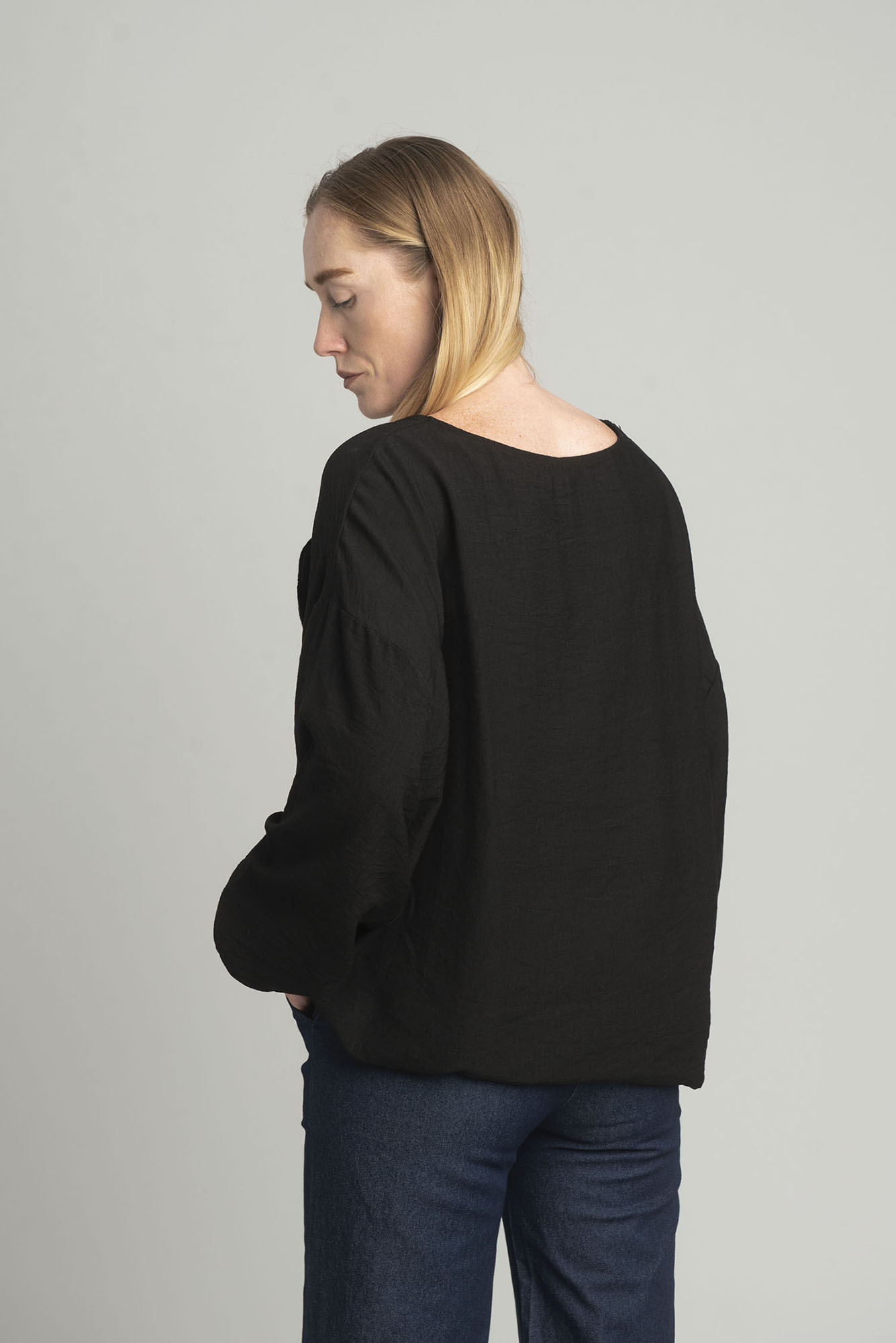 Black oversize blouse with a decorative flower