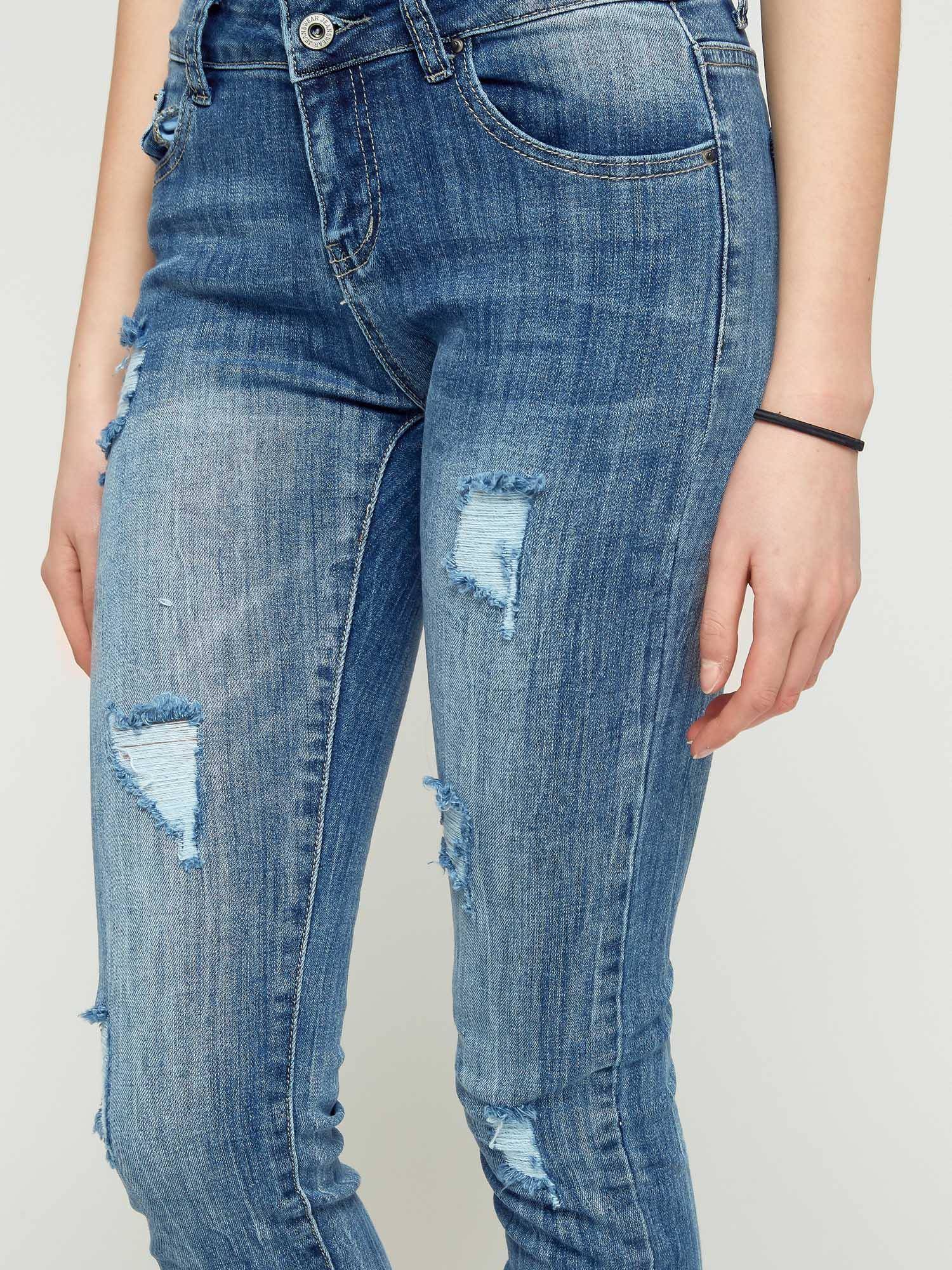 Jeans with tears and decorative zipper blue