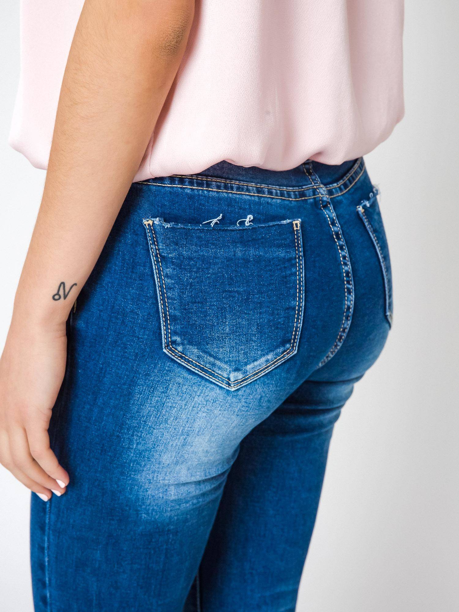Jeans decorated with cuts and rhinestones on the knees navy blue