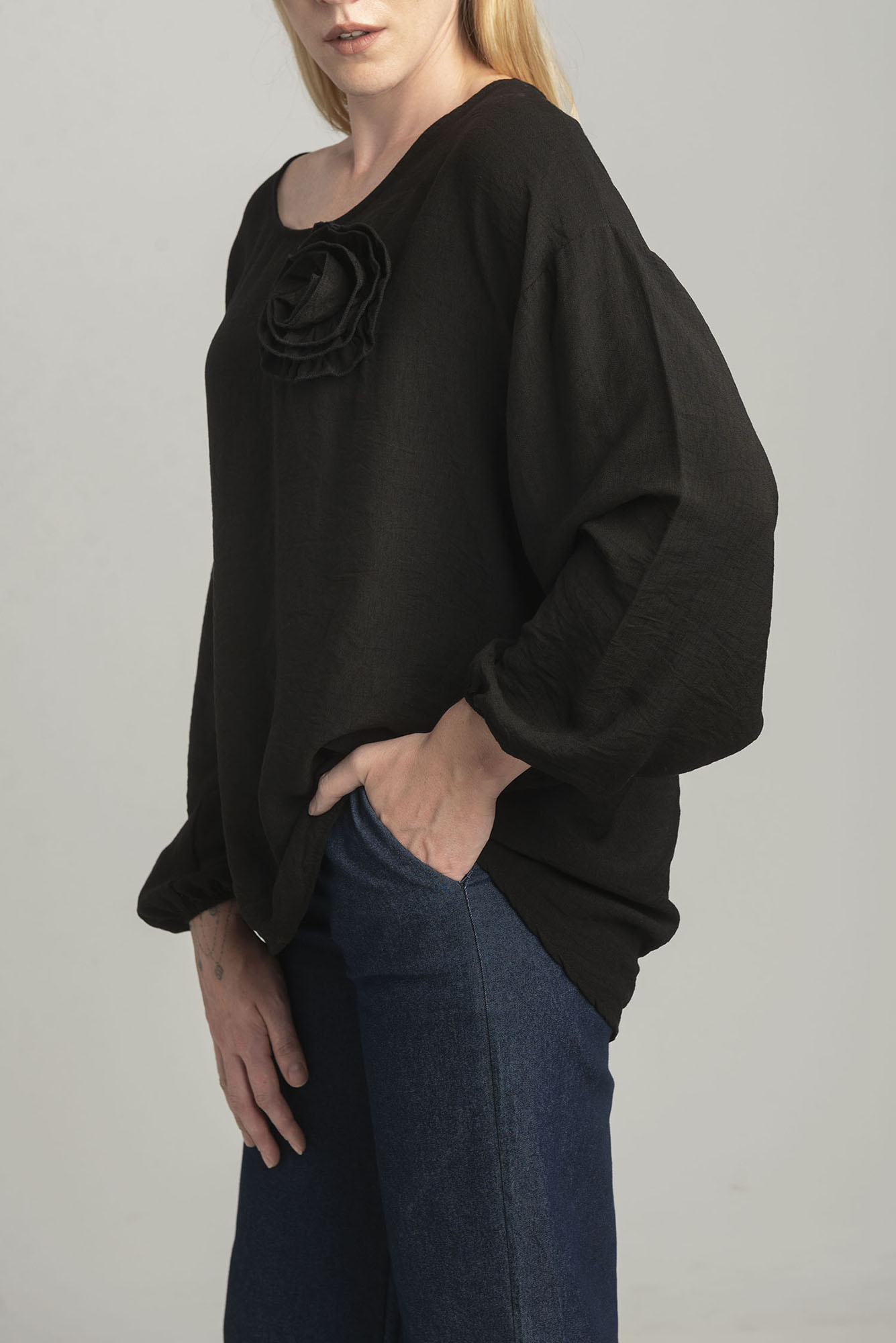 Black oversize blouse with a decorative flower