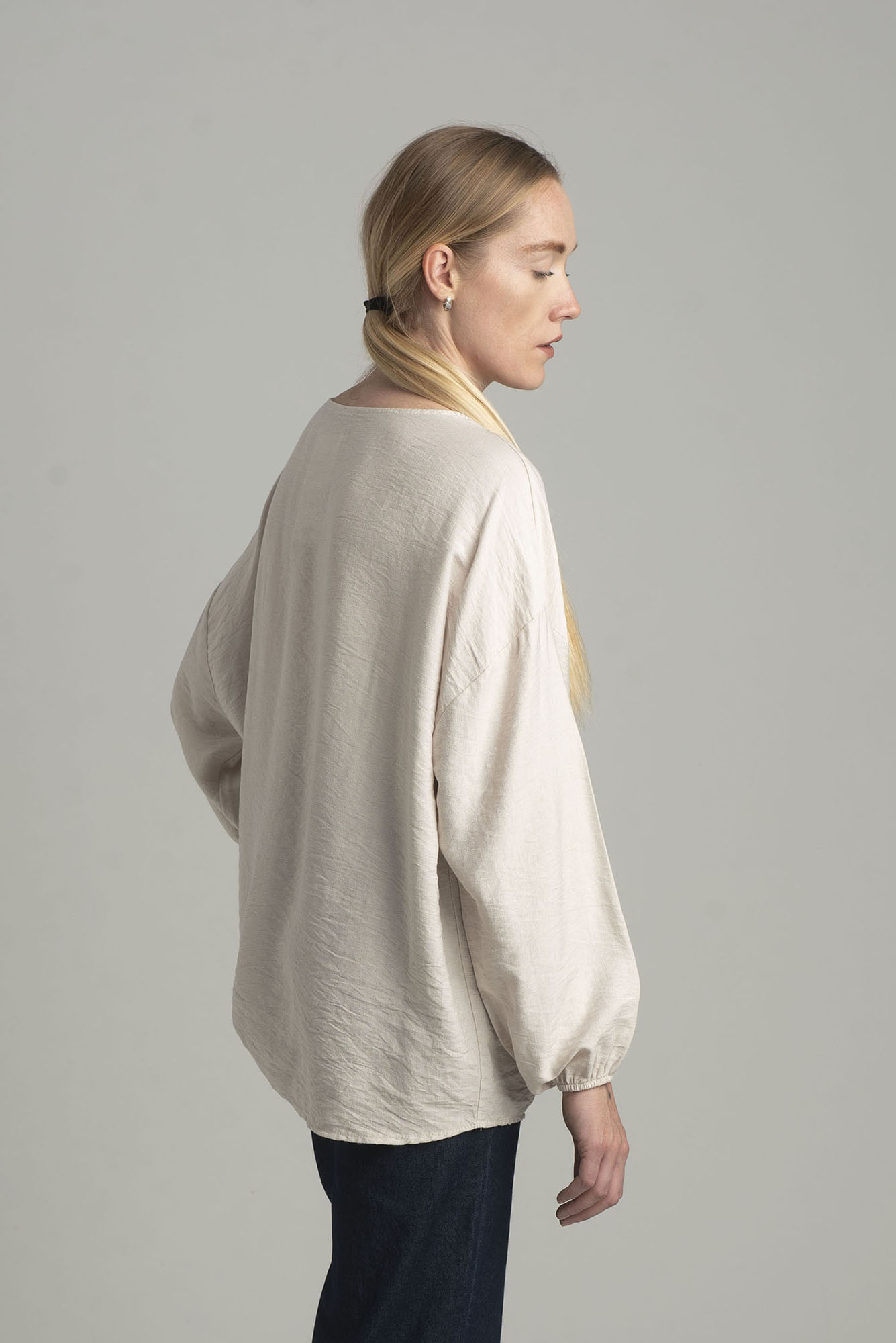 Beige oversize blouse with a decorative flower