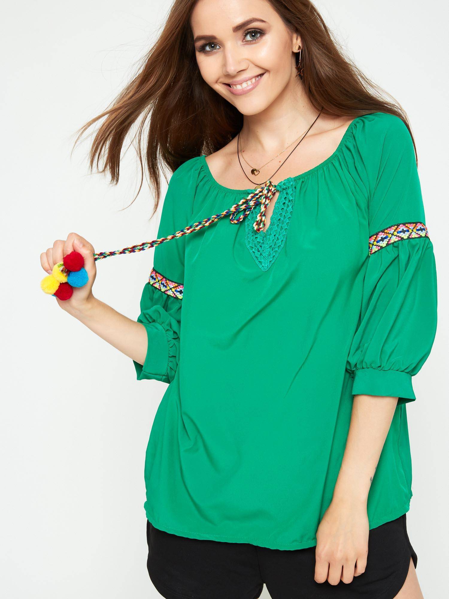 Blouse with decorative green binding