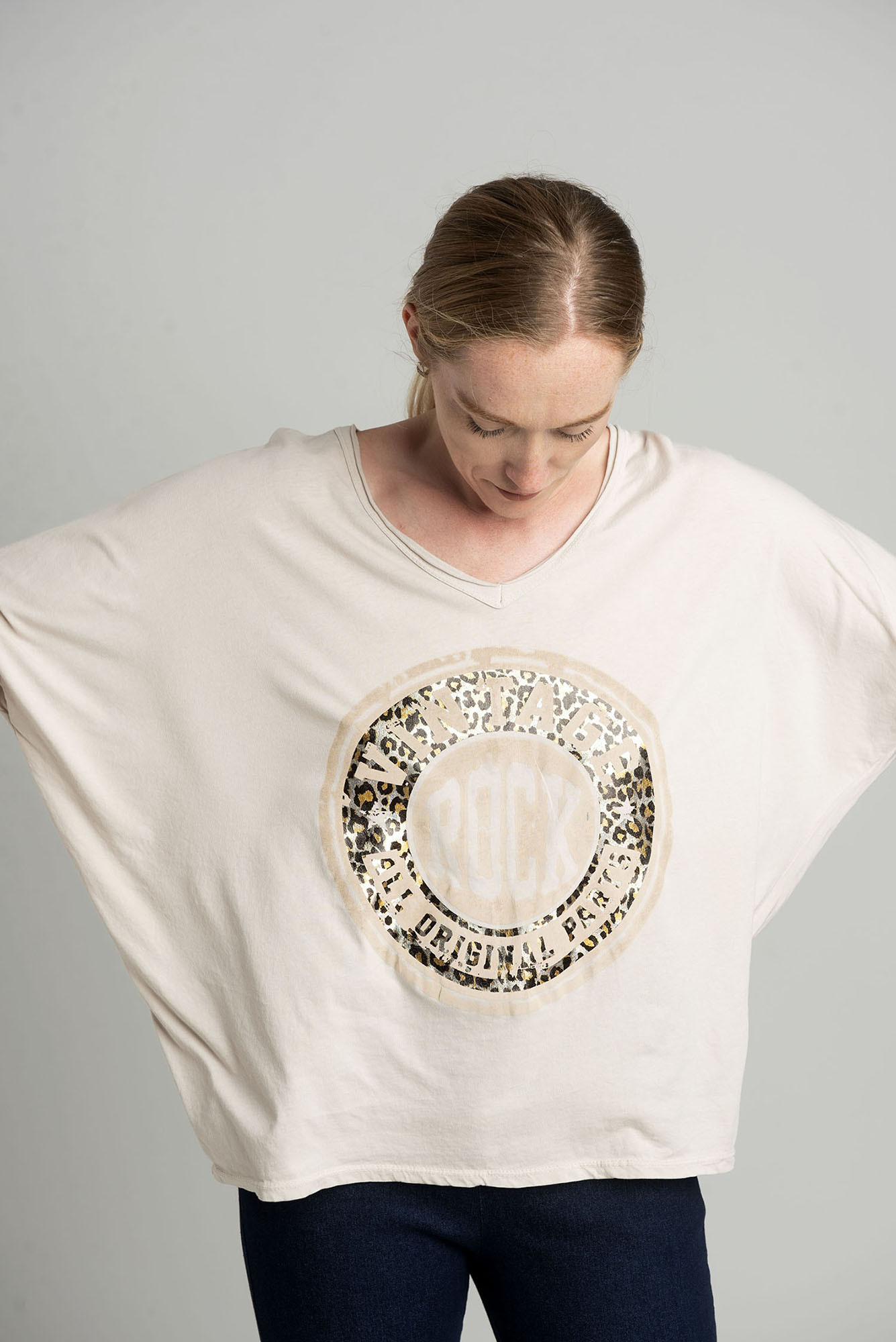 Beige oversize blouse with a shiny print