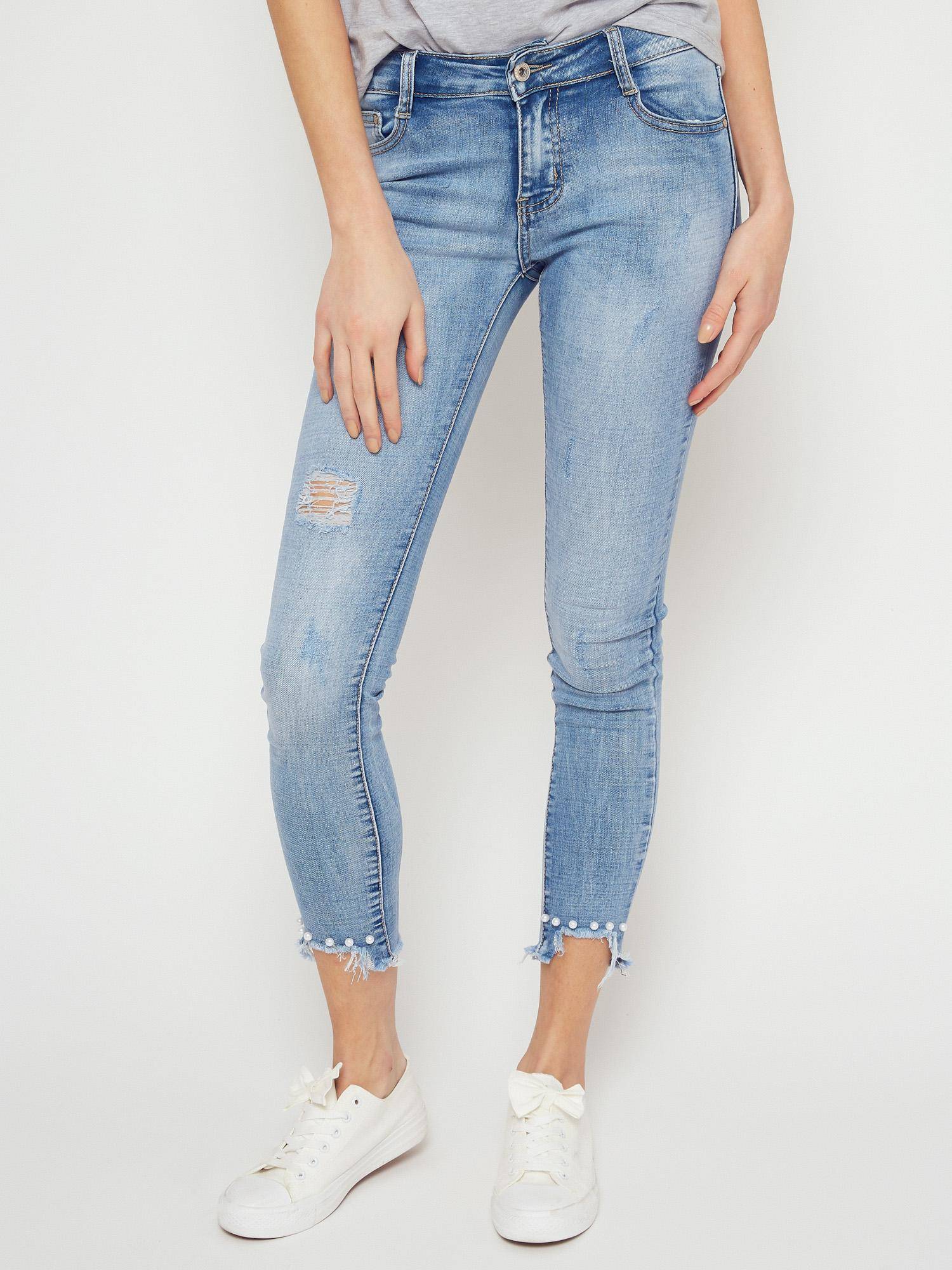 Denim jeans decorated with blue pearls