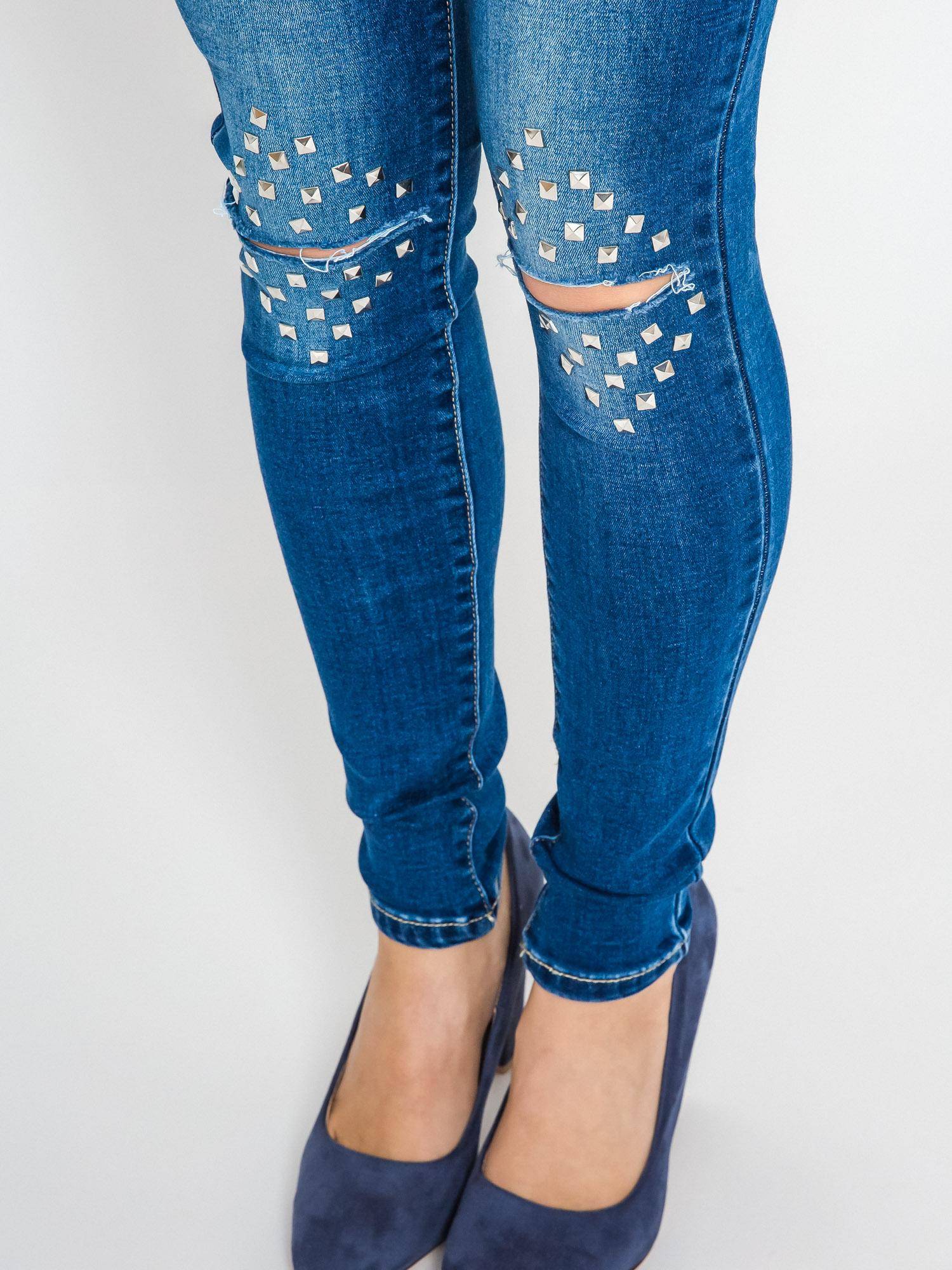 Jeans decorated with cuts and rhinestones on the knees navy blue