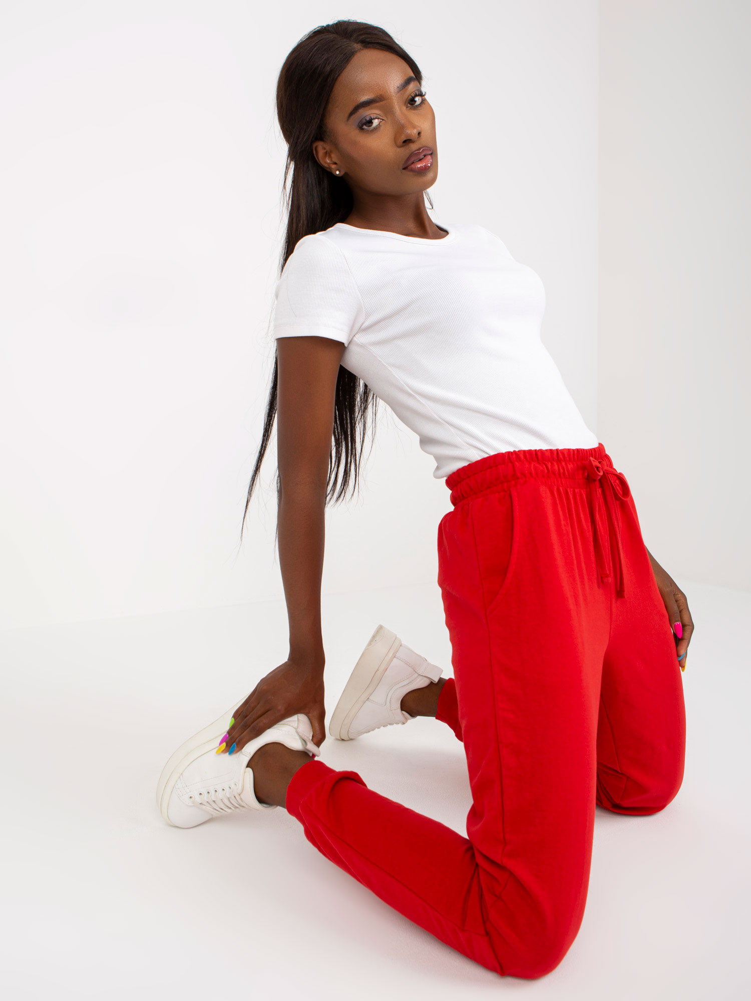 Red sweatpants tied at the waist