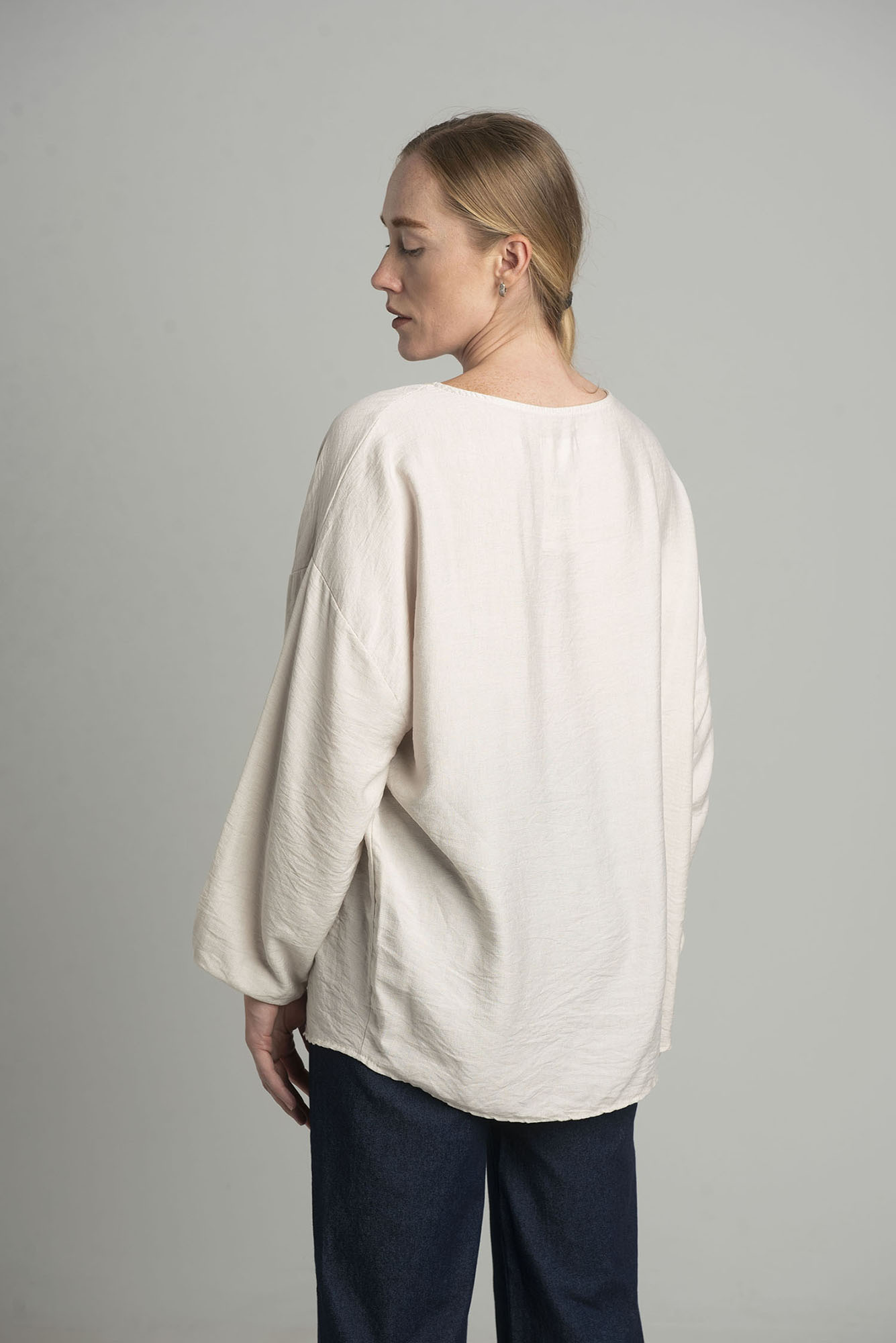 Beige oversize blouse with a decorative flower