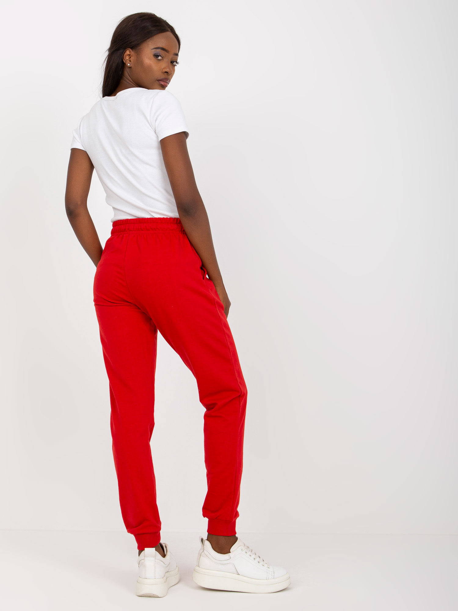 Red sweatpants tied at the waist