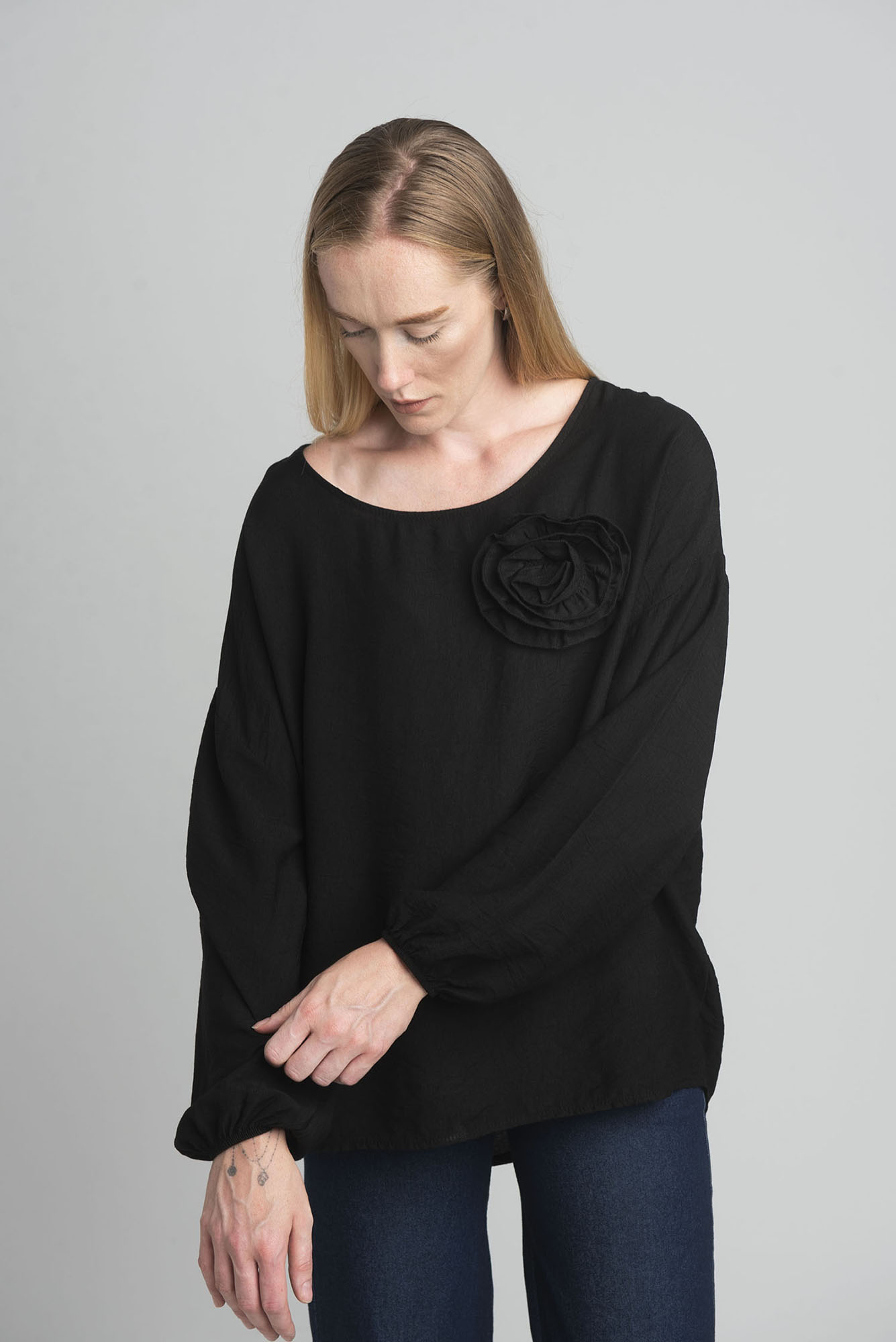 Black oversize blouse with a decorative flower