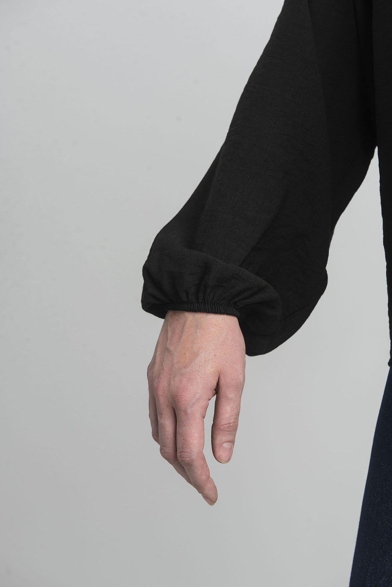 Black oversize blouse with a decorative flower