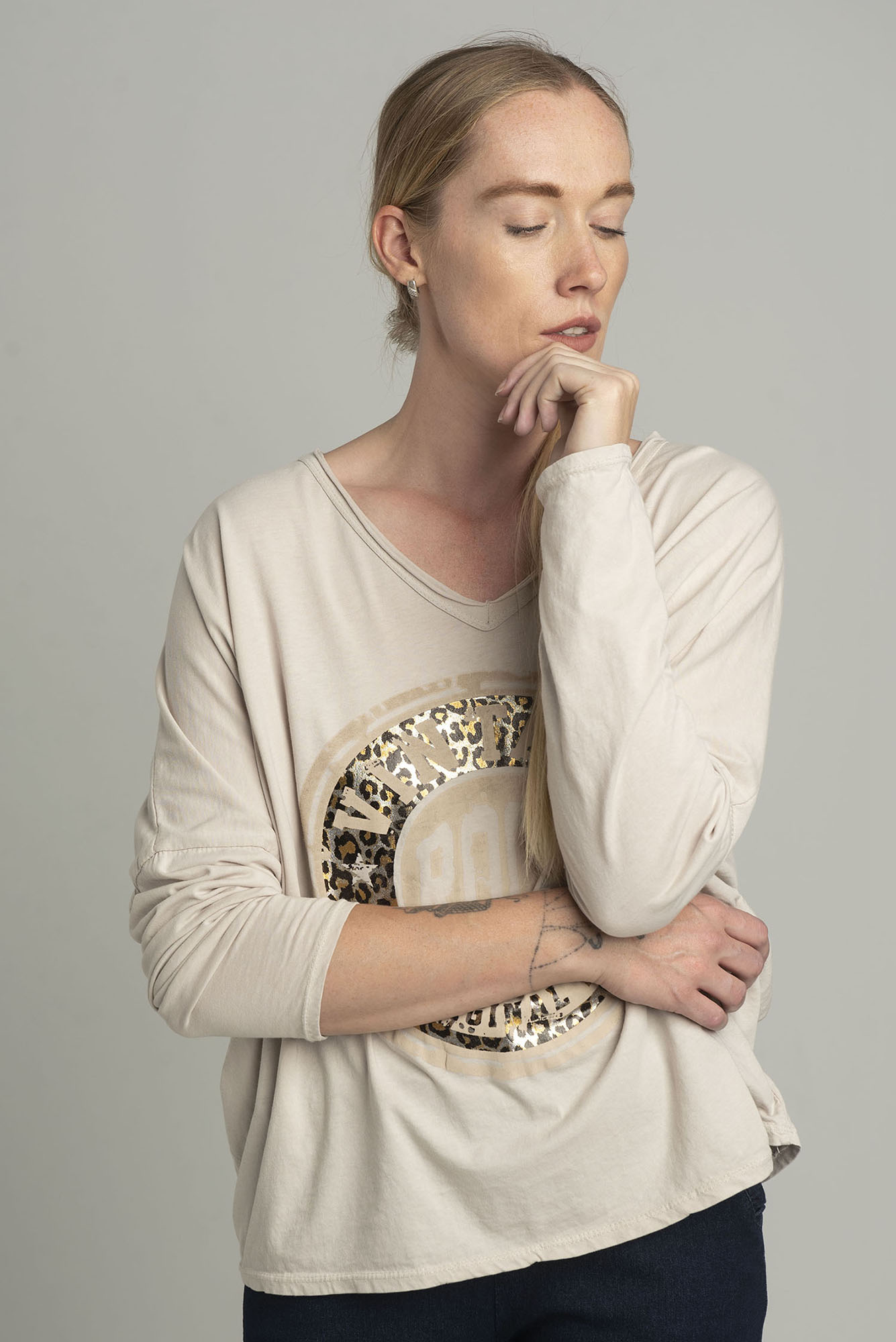 Beige oversize blouse with a shiny print