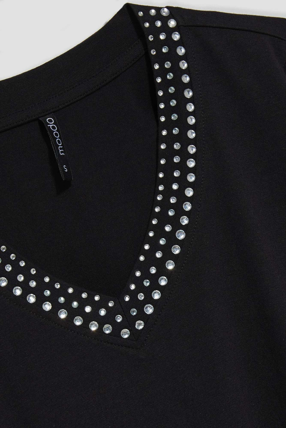 Plain blouse with a decorative neckline