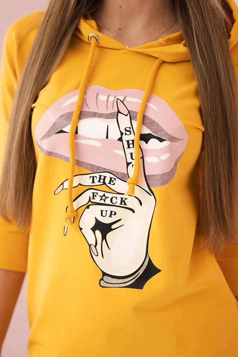 Dress with a longer back and a colorful mustard print