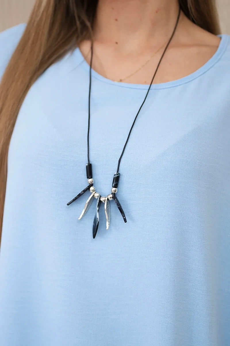 Oversized blouse with blue pendant