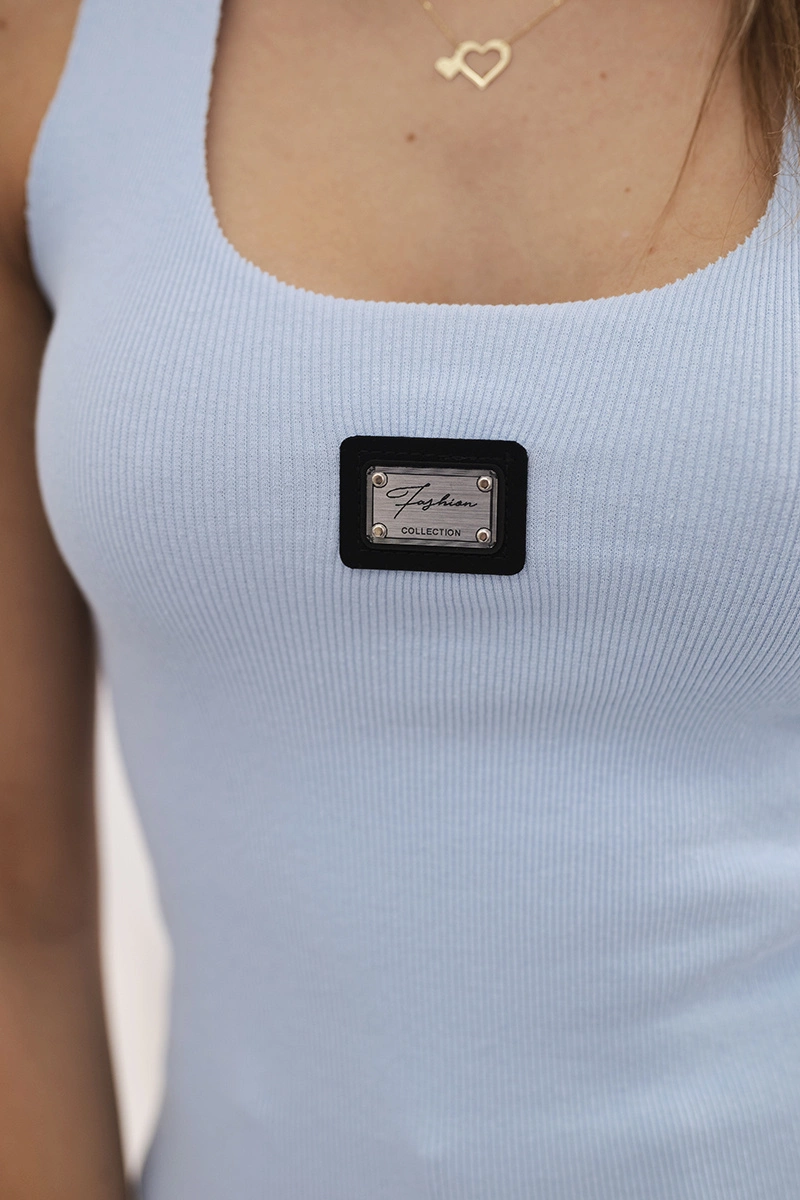 Striped blouse with blue metal plate