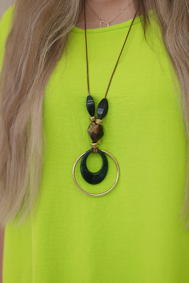 Oversized blouse with kiwi pendant