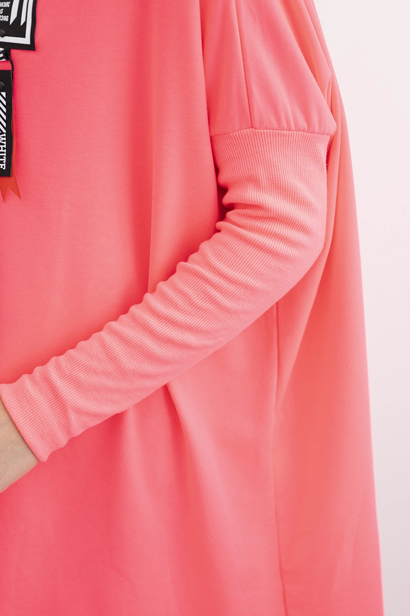 Oversized sweatshirt with asymmetrical sides in pink neon color
