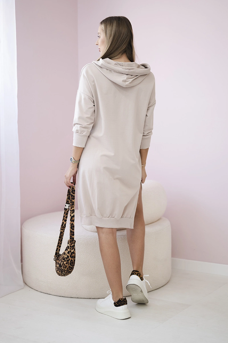 Dress with a hood and a longer back in beige color