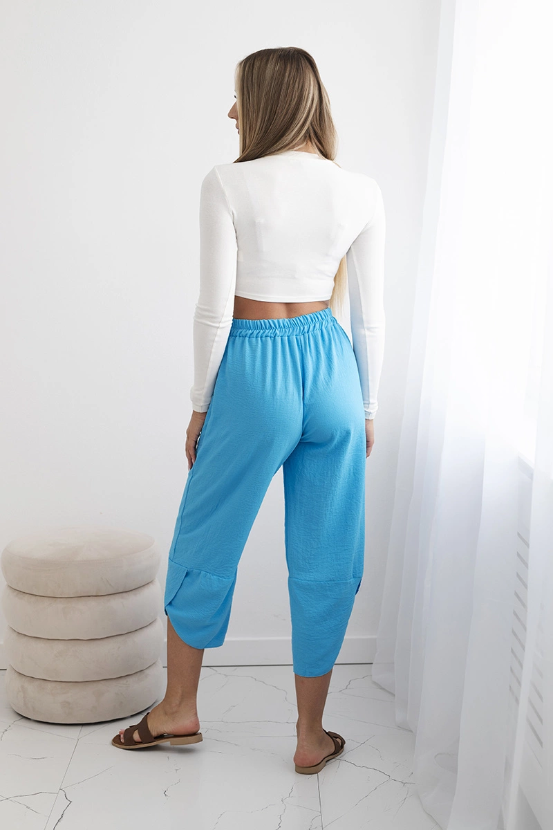 Turquoise trousers with wide legs and pockets