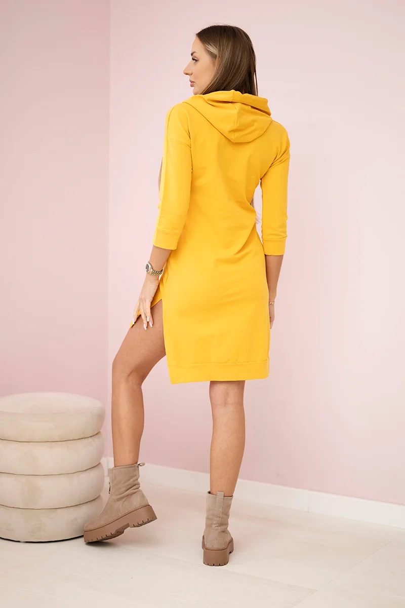 Dress with a longer back and a colorful mustard print