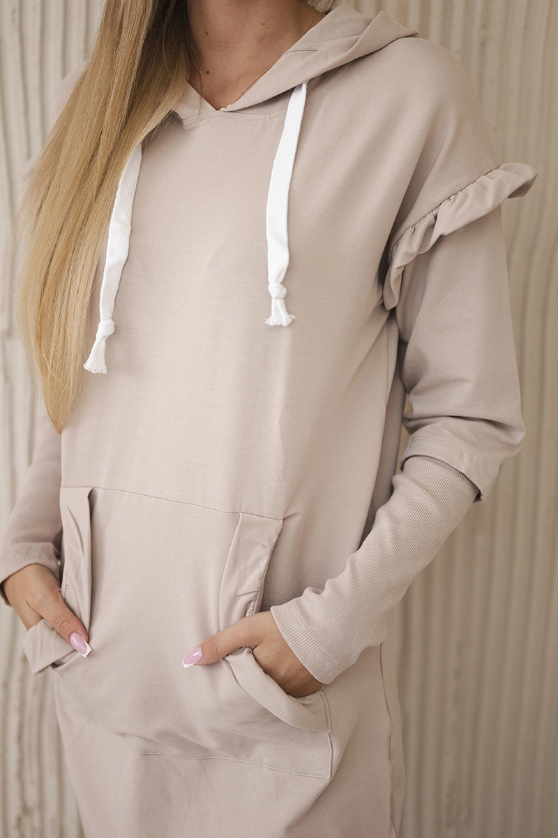 Dress with decorative ruffles and beige hood