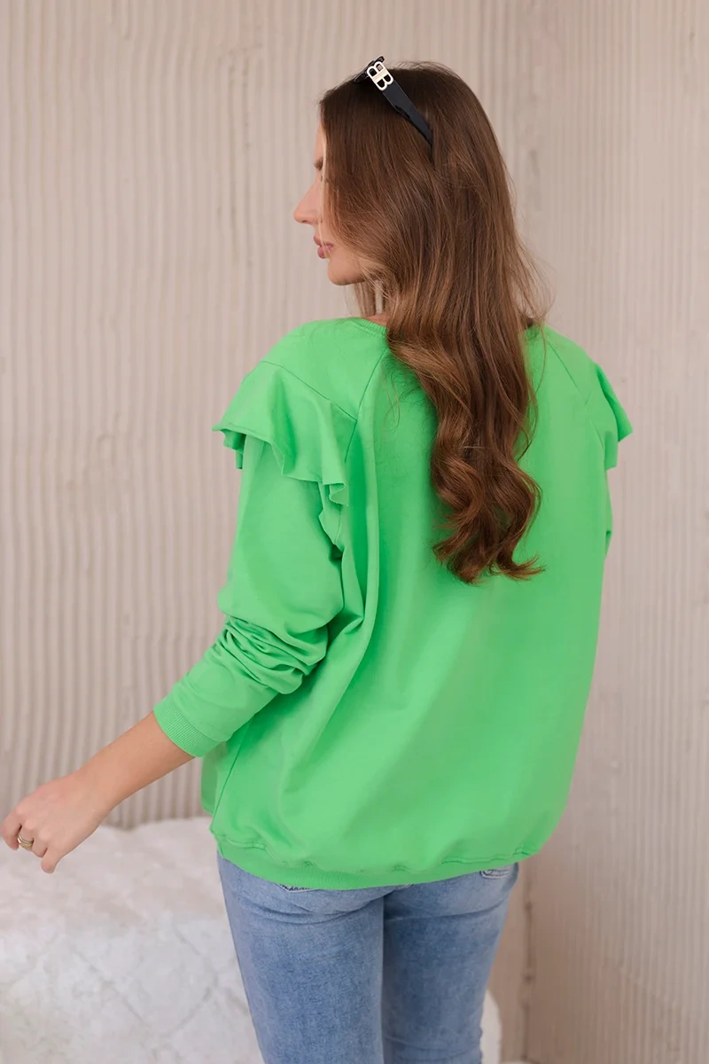 Cotton blouse with ruffles on the shoulders in light green color