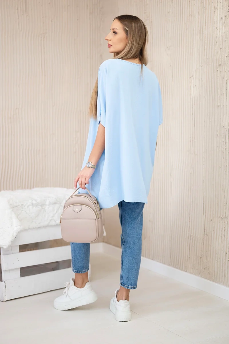 Oversized blouse with blue pendant